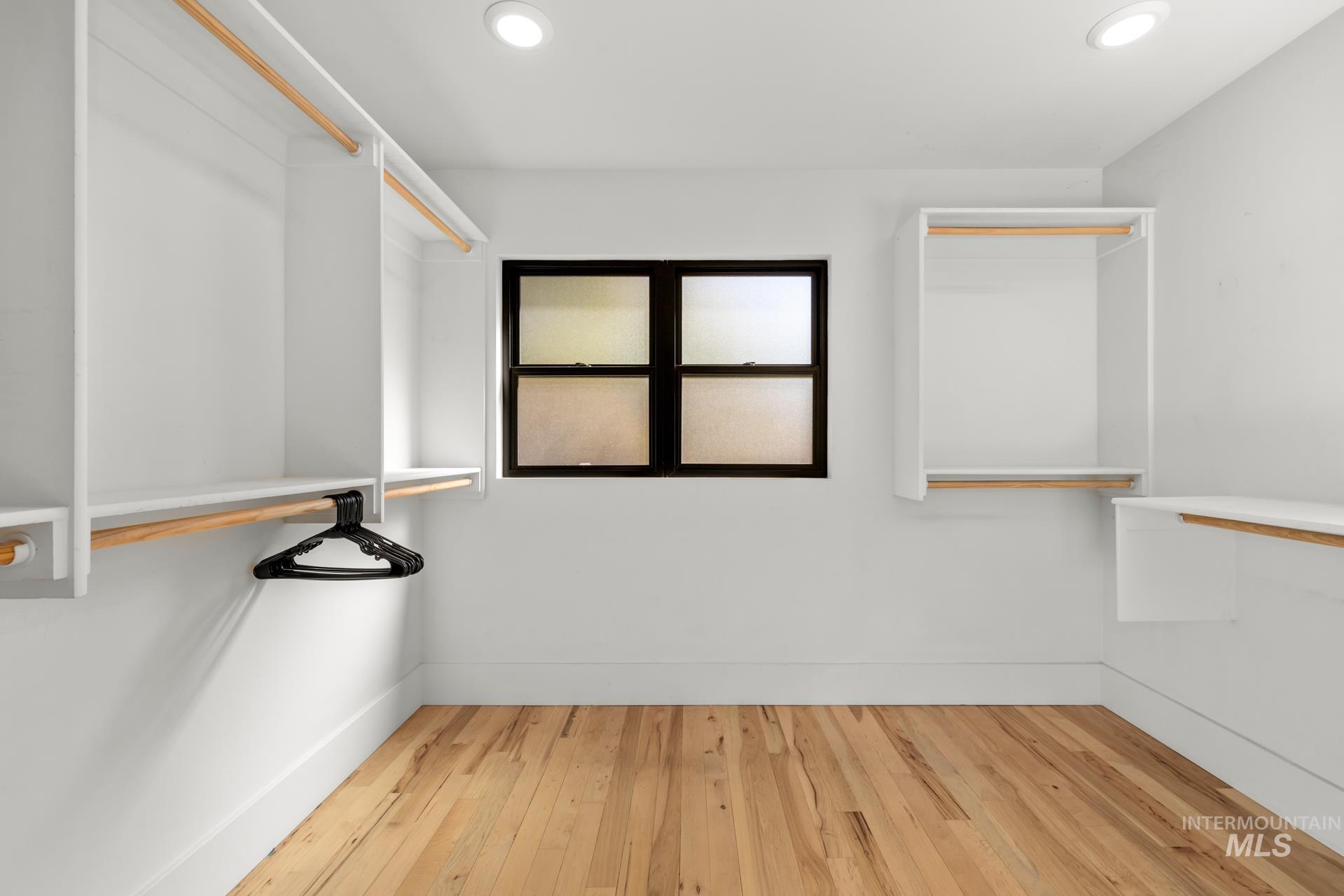 Walk in closet featuring light wood-style floors
