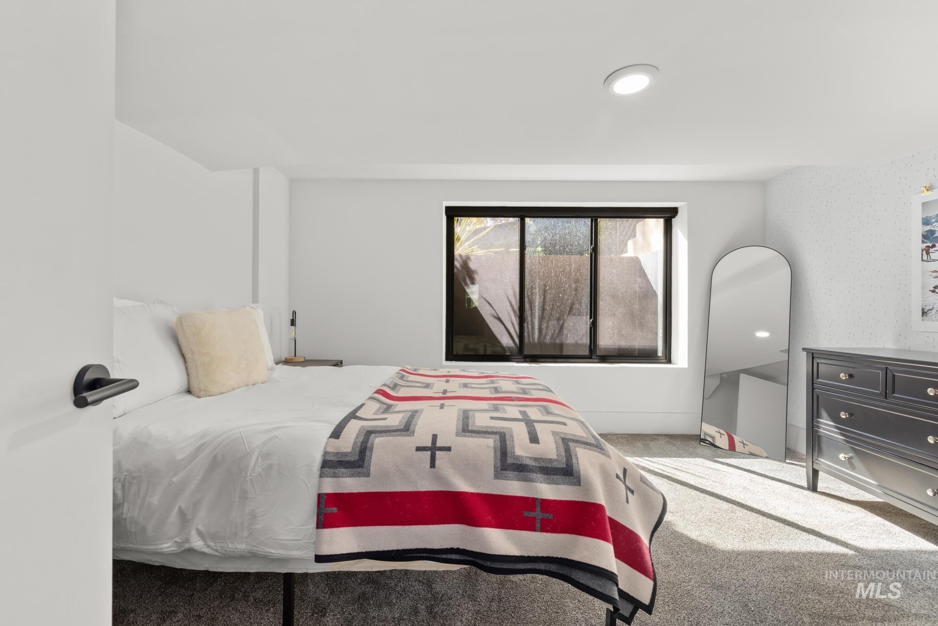 Bedroom featuring carpet floors and baseboards