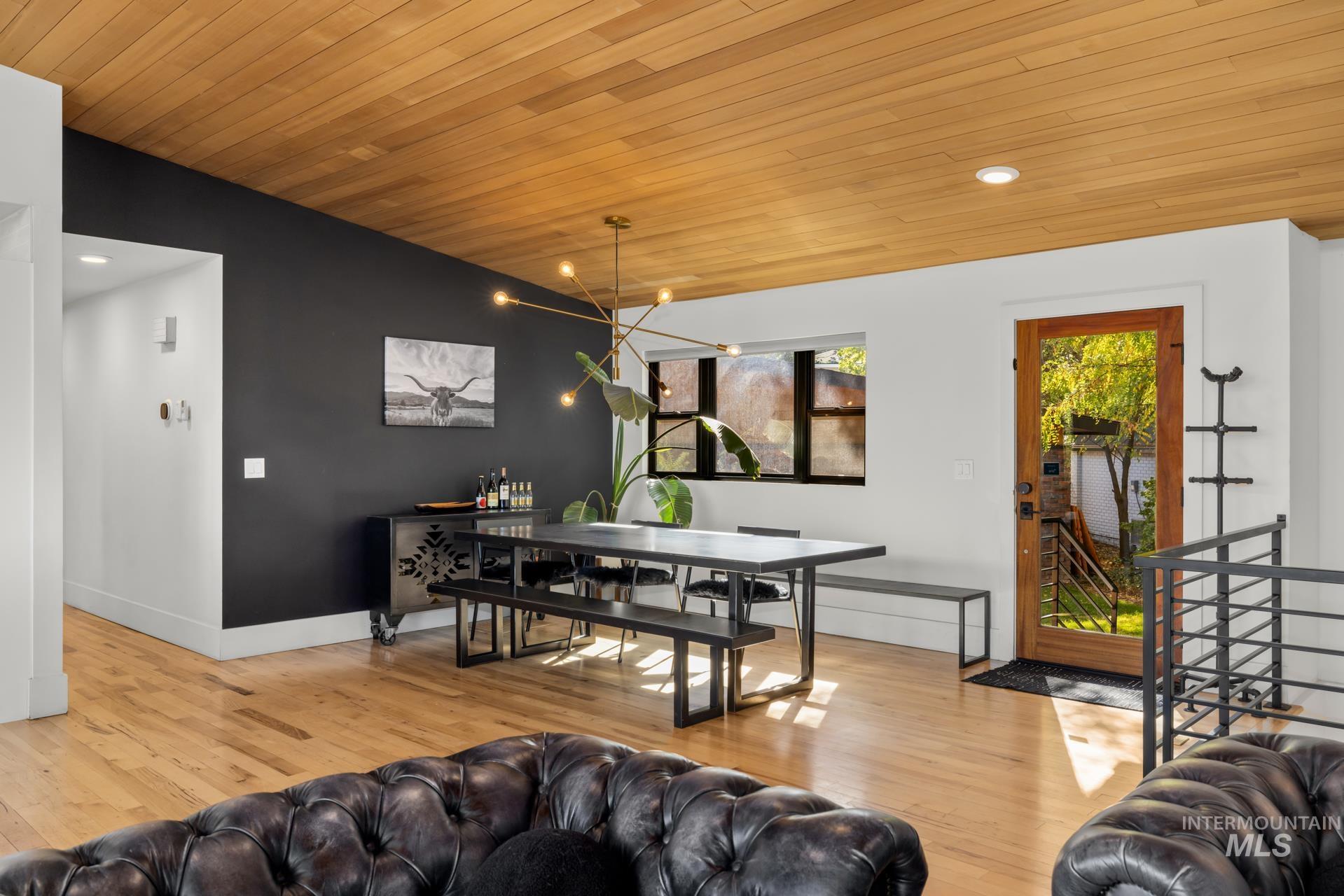 Living room featuring wood ceiling, light wood finished floors, recessed lighting, and a chandelier