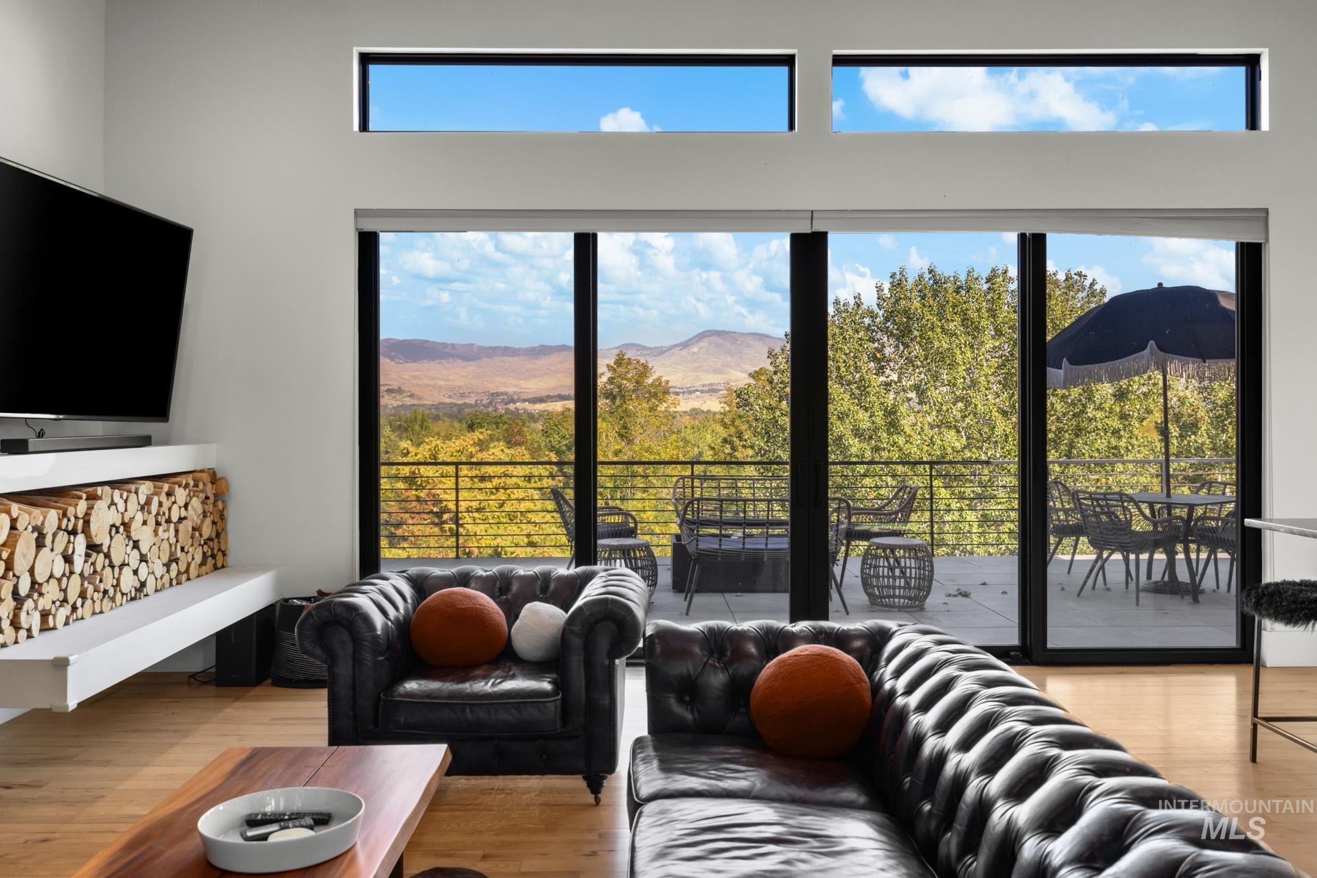 Living room featuring light wood-style floors and a mountain view