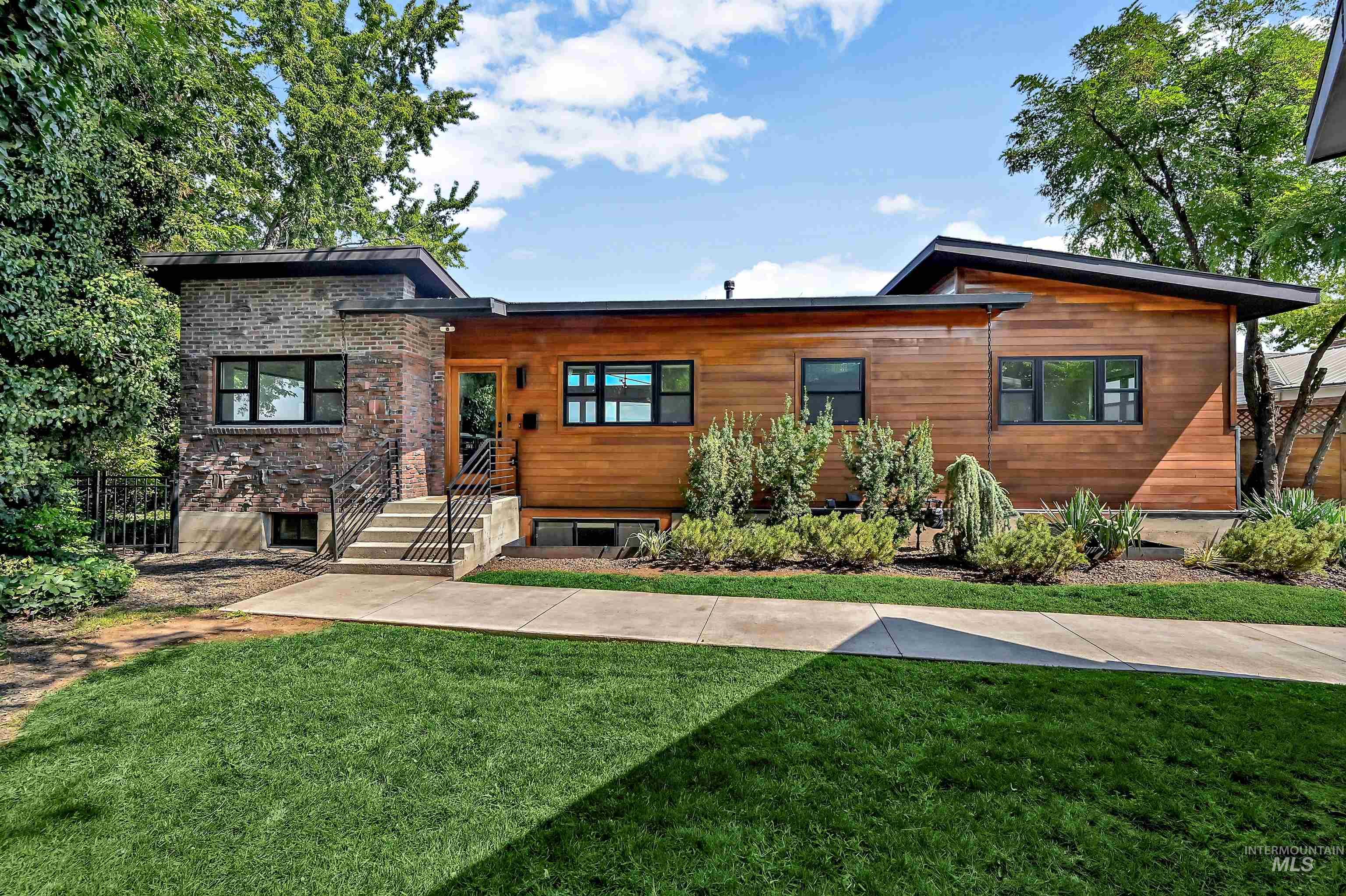 View of front of house with a front lawn and brick siding