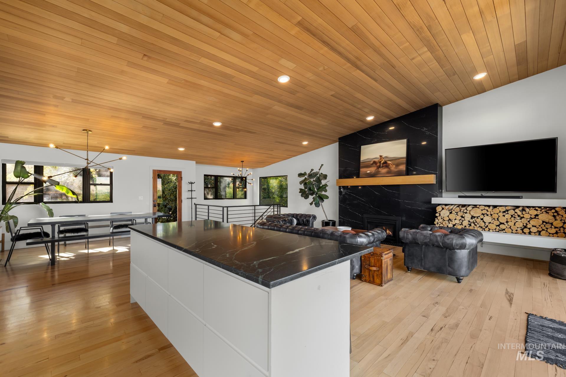 Kitchen featuring modern cabinets, white cabinets, decorative light fixtures, recessed lighting, and wooden ceiling
