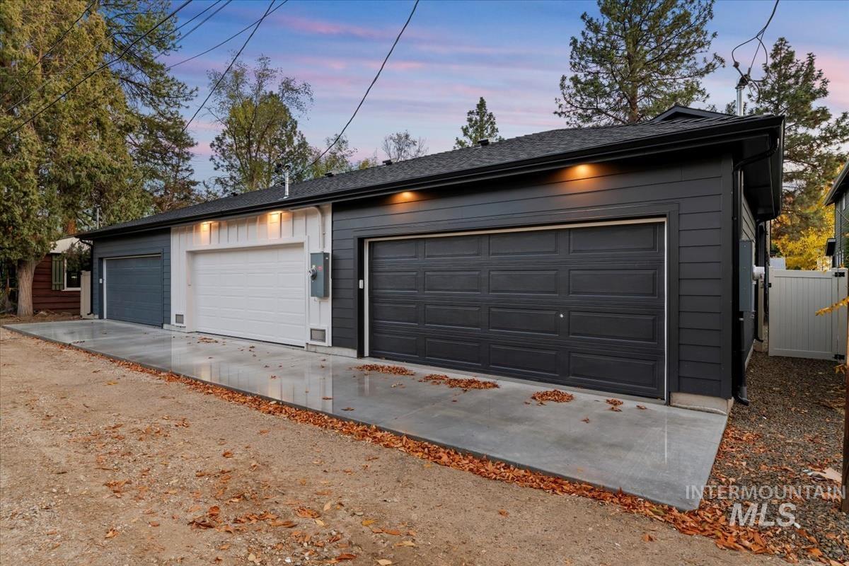 Garage at dusk featuring driveway