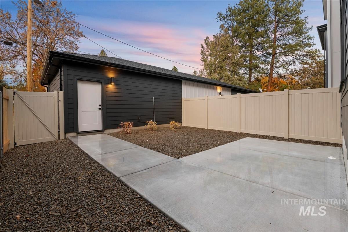 Property exterior at dusk featuring a gate