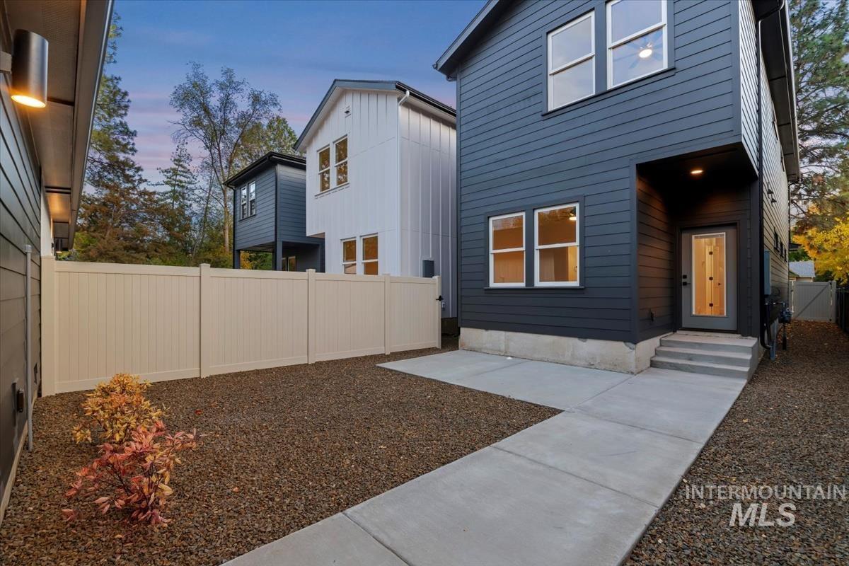 Rear view of property with a fenced backyard and board and batten siding