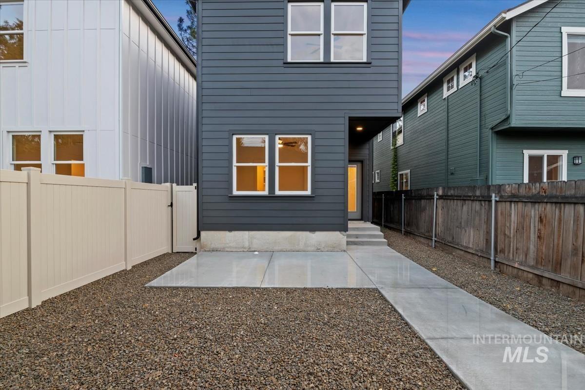 Rear view of house with a fenced backyard and board and batten siding