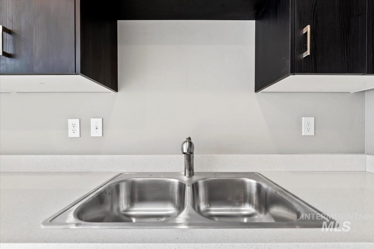 Kitchen view of light stone countertops and modern cabinets