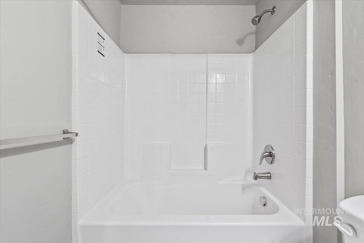 Full bath featuring shower / washtub combination and toilet