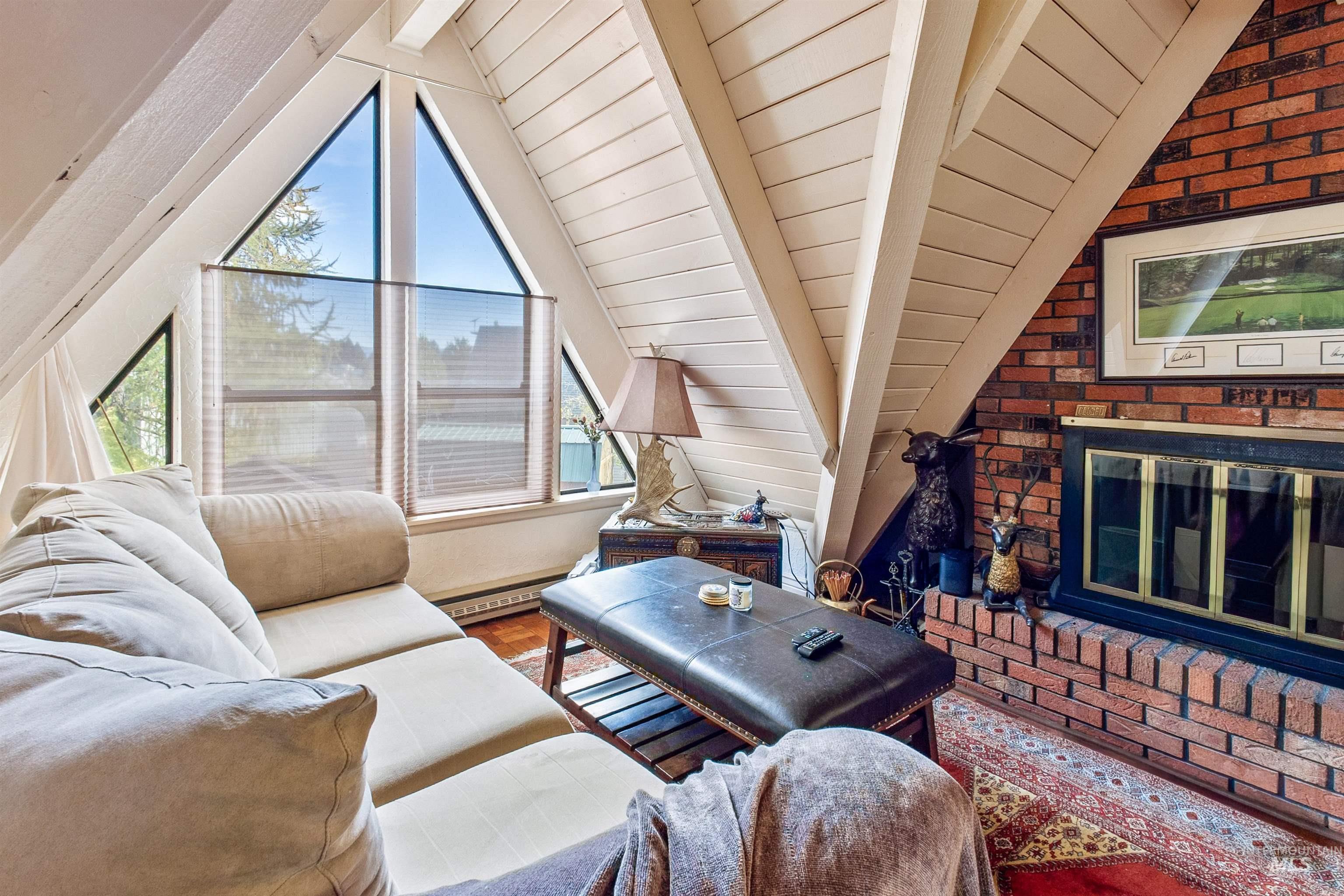 Loft with plenty of natural light, and wood finished floors