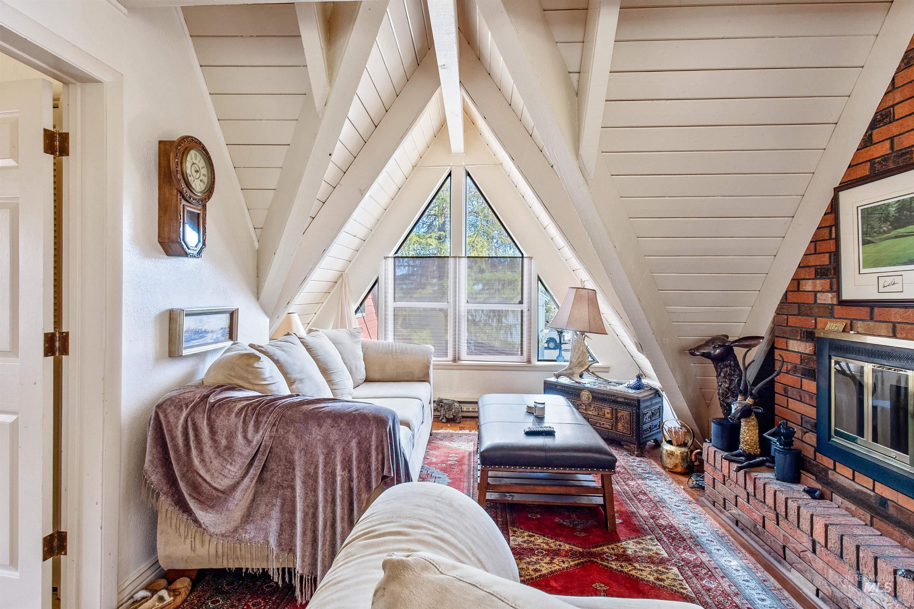 loft with a brick fireplace