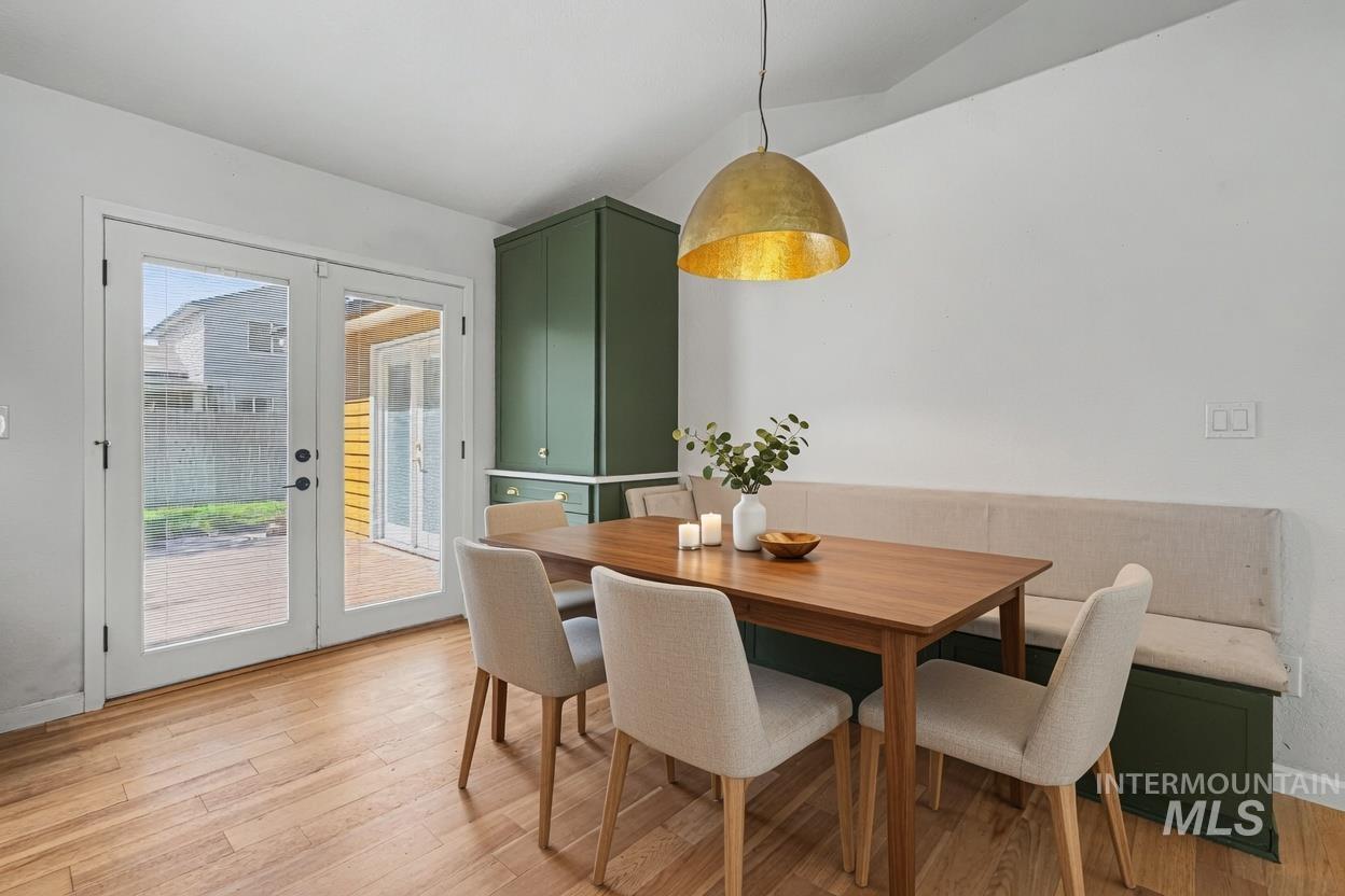 Room featuring wood-finish flooring, white walls, and a large overhead pendant light. *Virtually Staged photo*