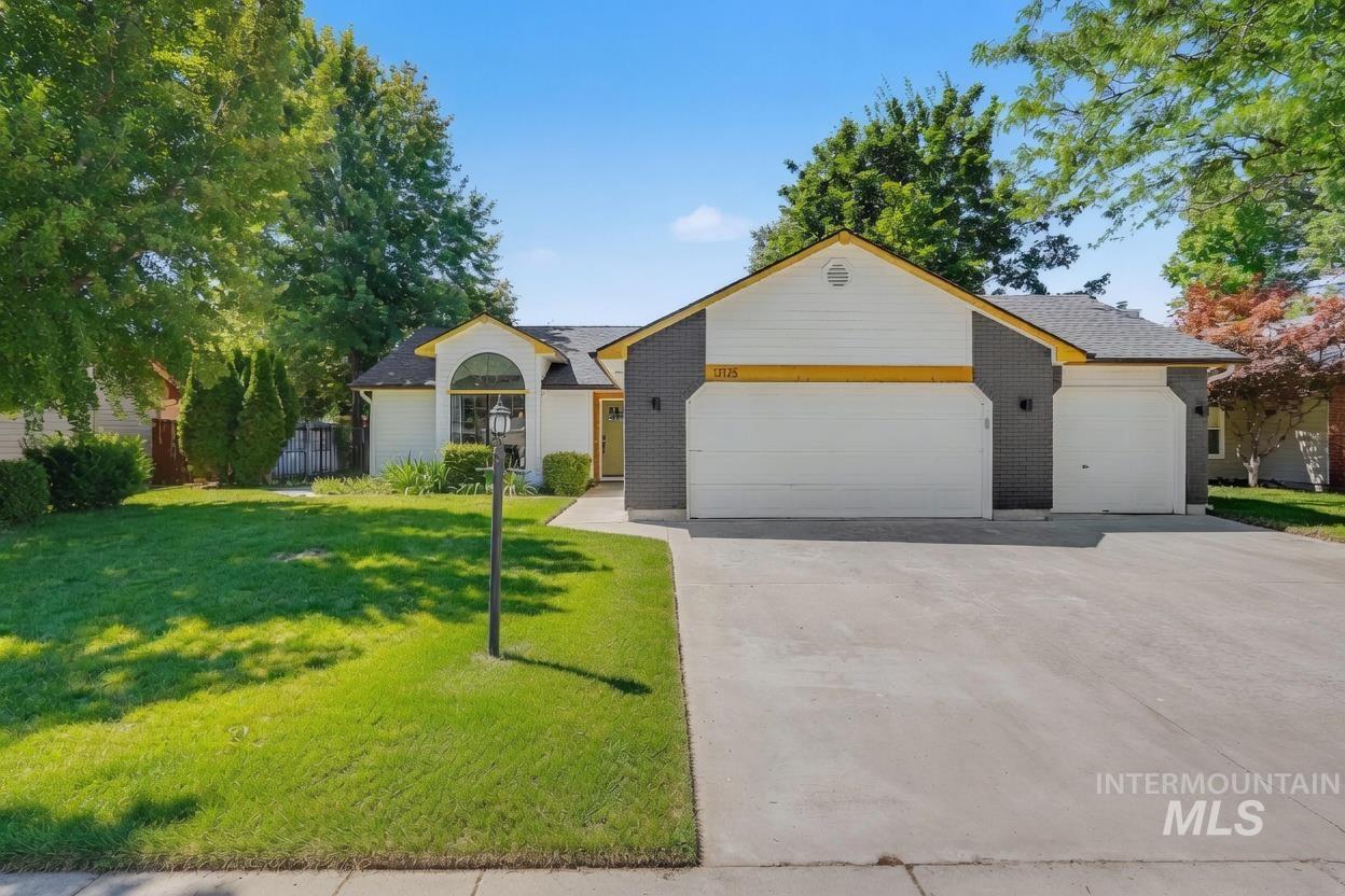Single-story residence featuring a two-car garage, an additional single-car garage, and a concrete driveway