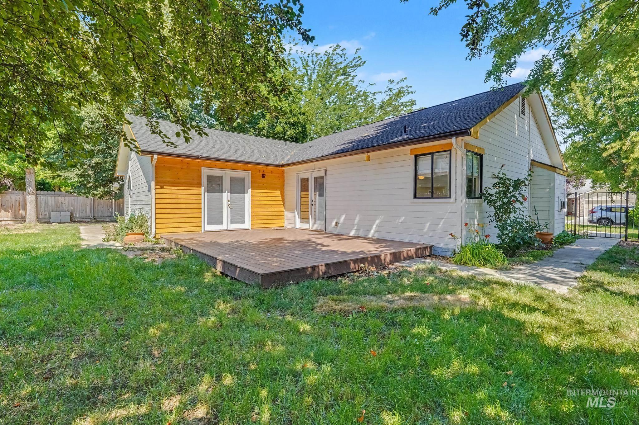 Rear exterior featuring a spacious wooden deck
