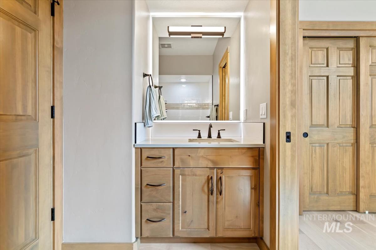 Bathroom featuring vanity and wood finished floors