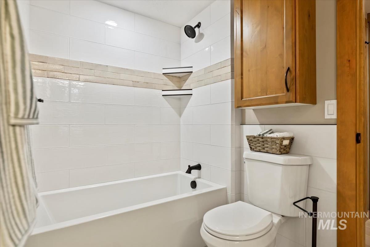 Full bath featuring  shower combination and toilet