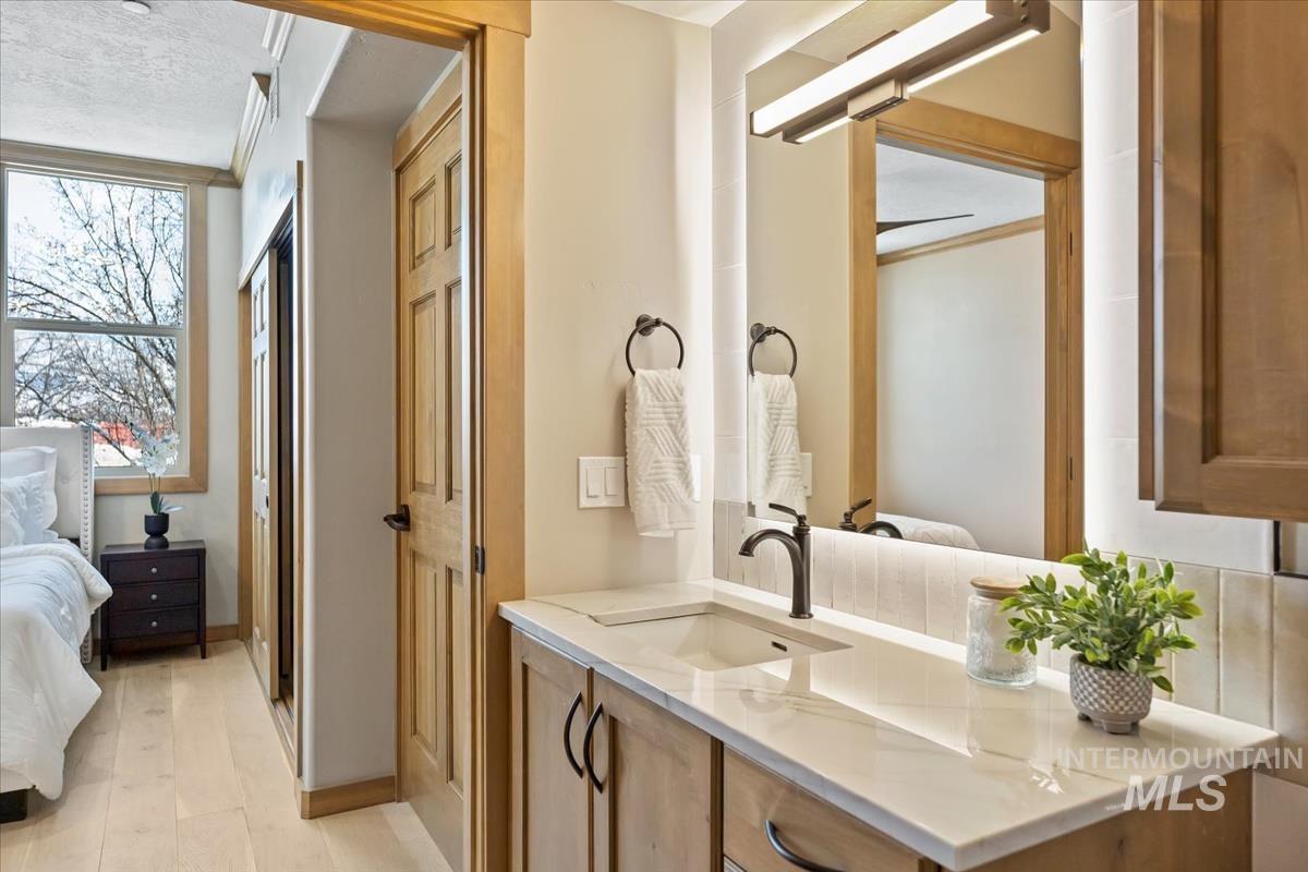 Full bath with ensuite bathroom and vanity