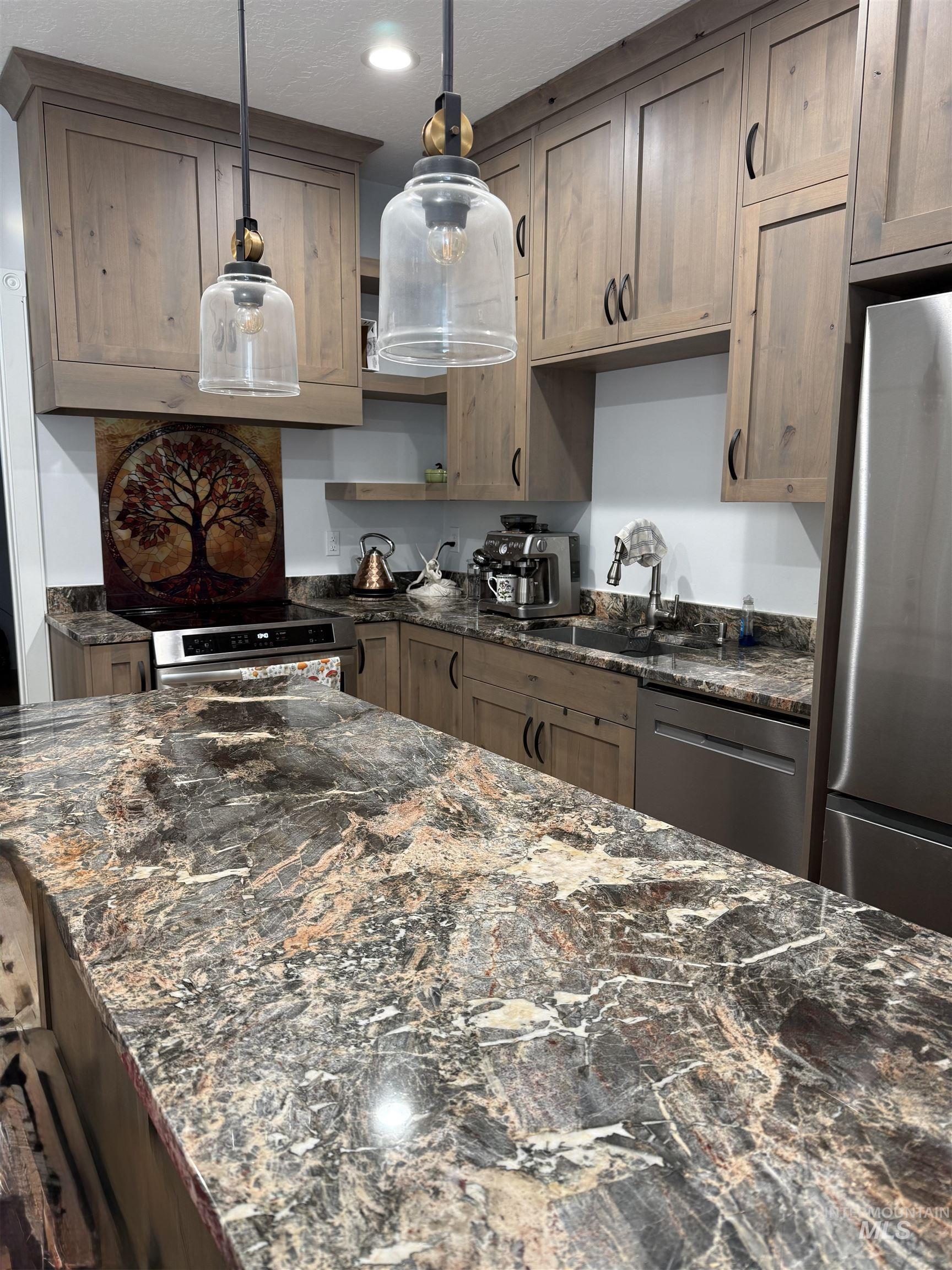Kitchen with granite countertops, stainless steel appliances, pendant lighting, recessed lighting, and open shelves