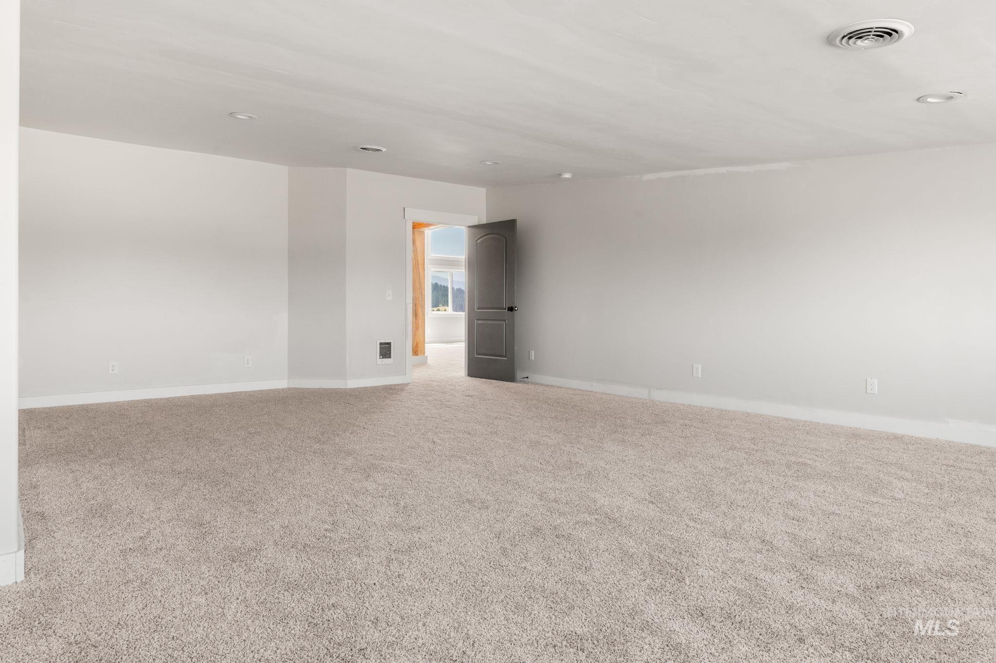Carpeted spare room featuring baseboards and recessed lighting