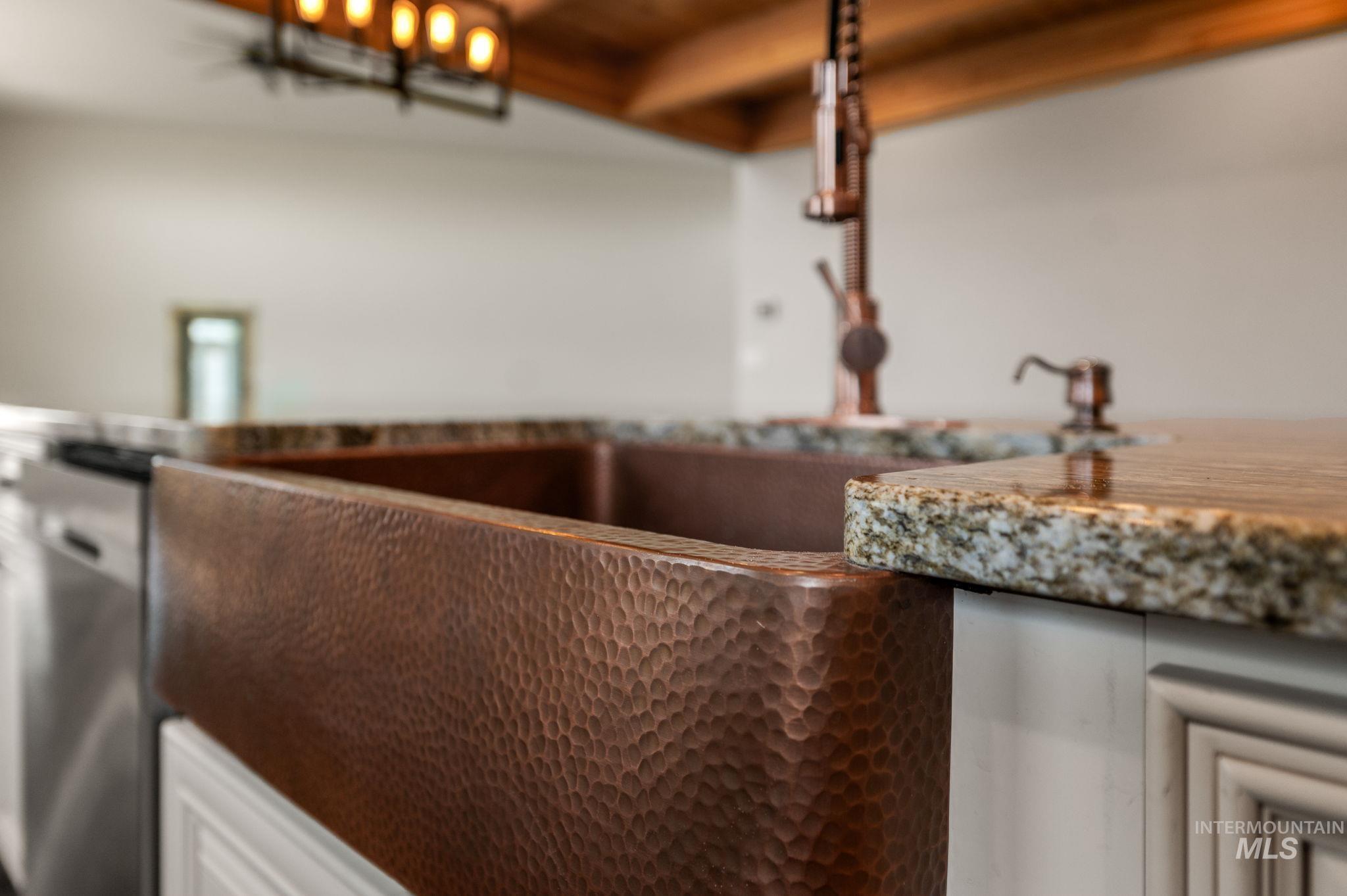 Kitchen view of dishwasher and white cabinets