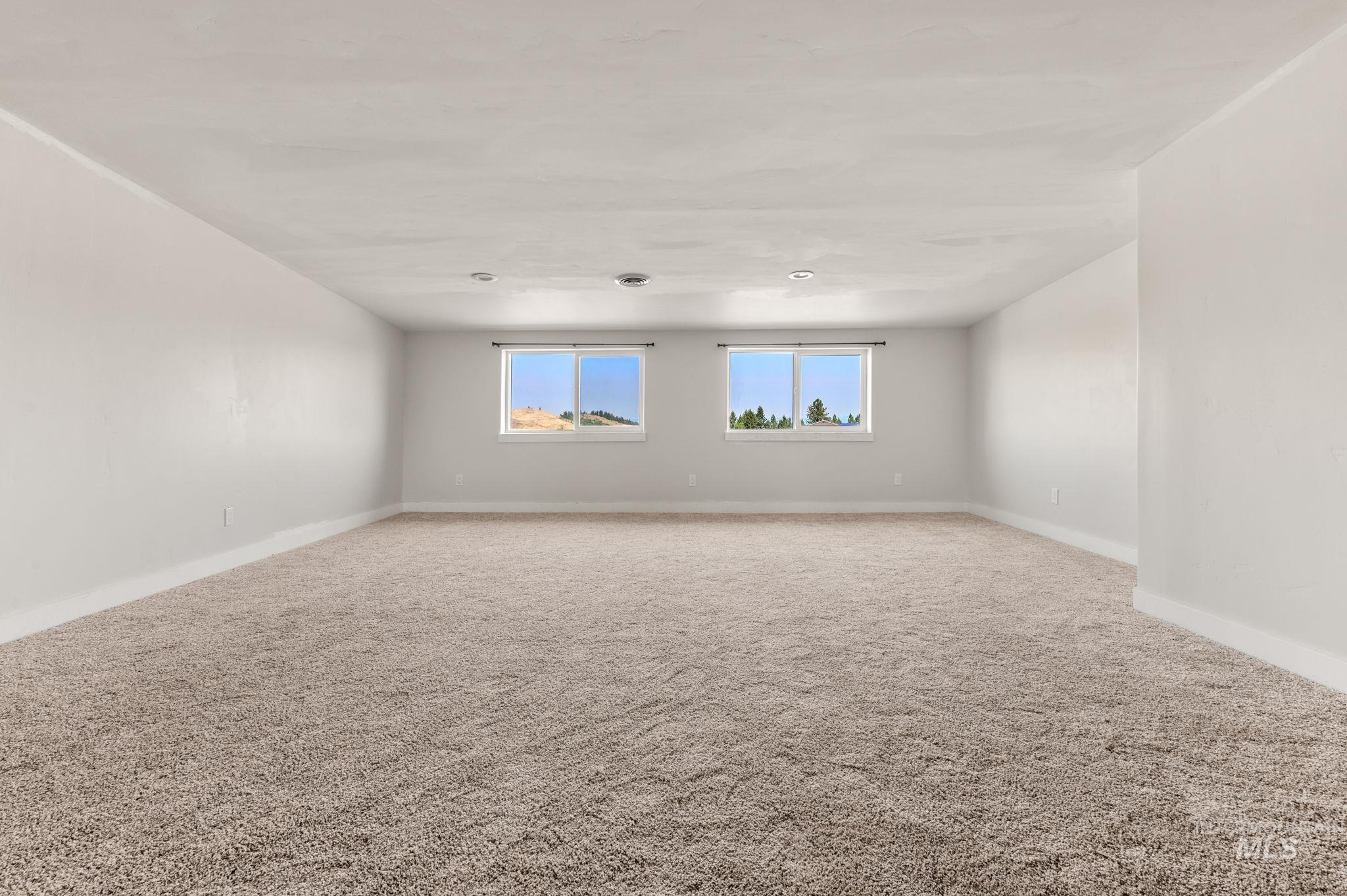 Unfurnished room featuring carpet flooring and baseboards