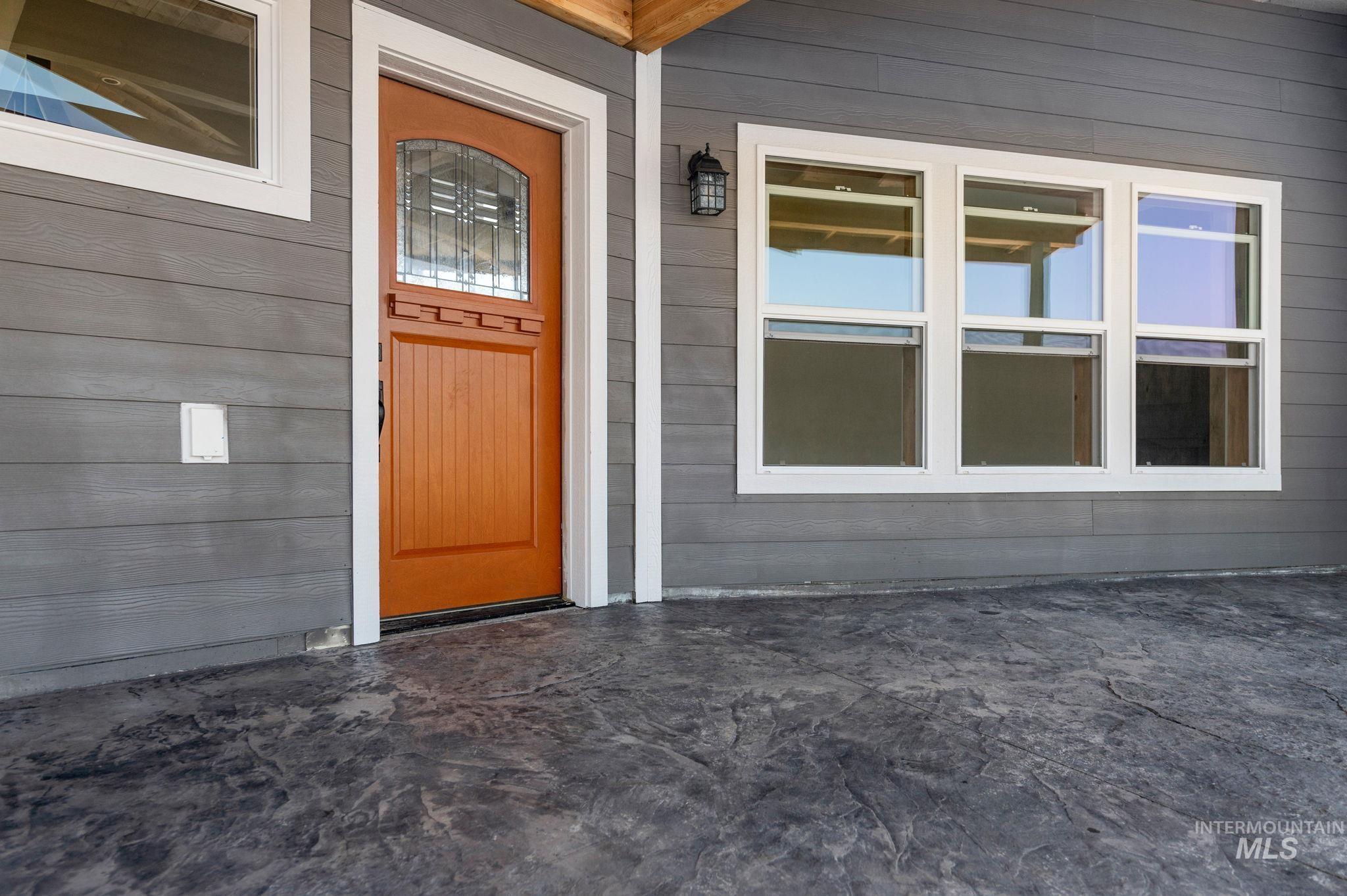 Doorway to property featuring a patio