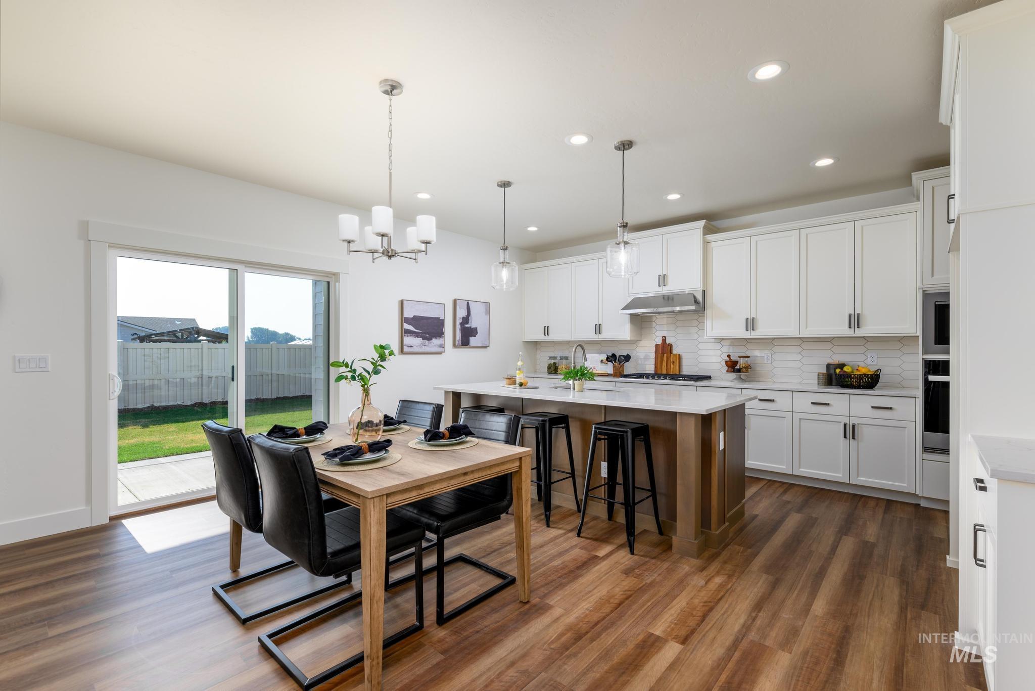 Dining room featuring recessed lighting, dark wood-style floors, and a chandelier