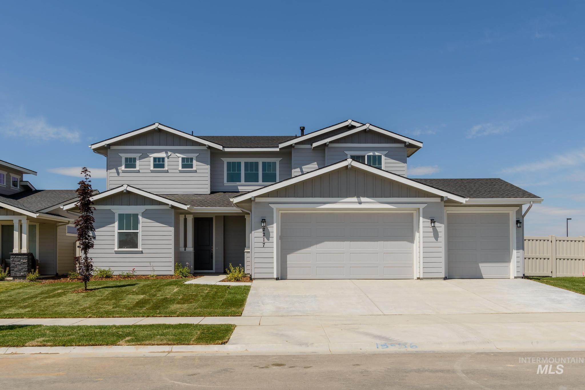 Craftsman-style house with board and batten siding, roof with shingles, concrete driveway, and an attached garage