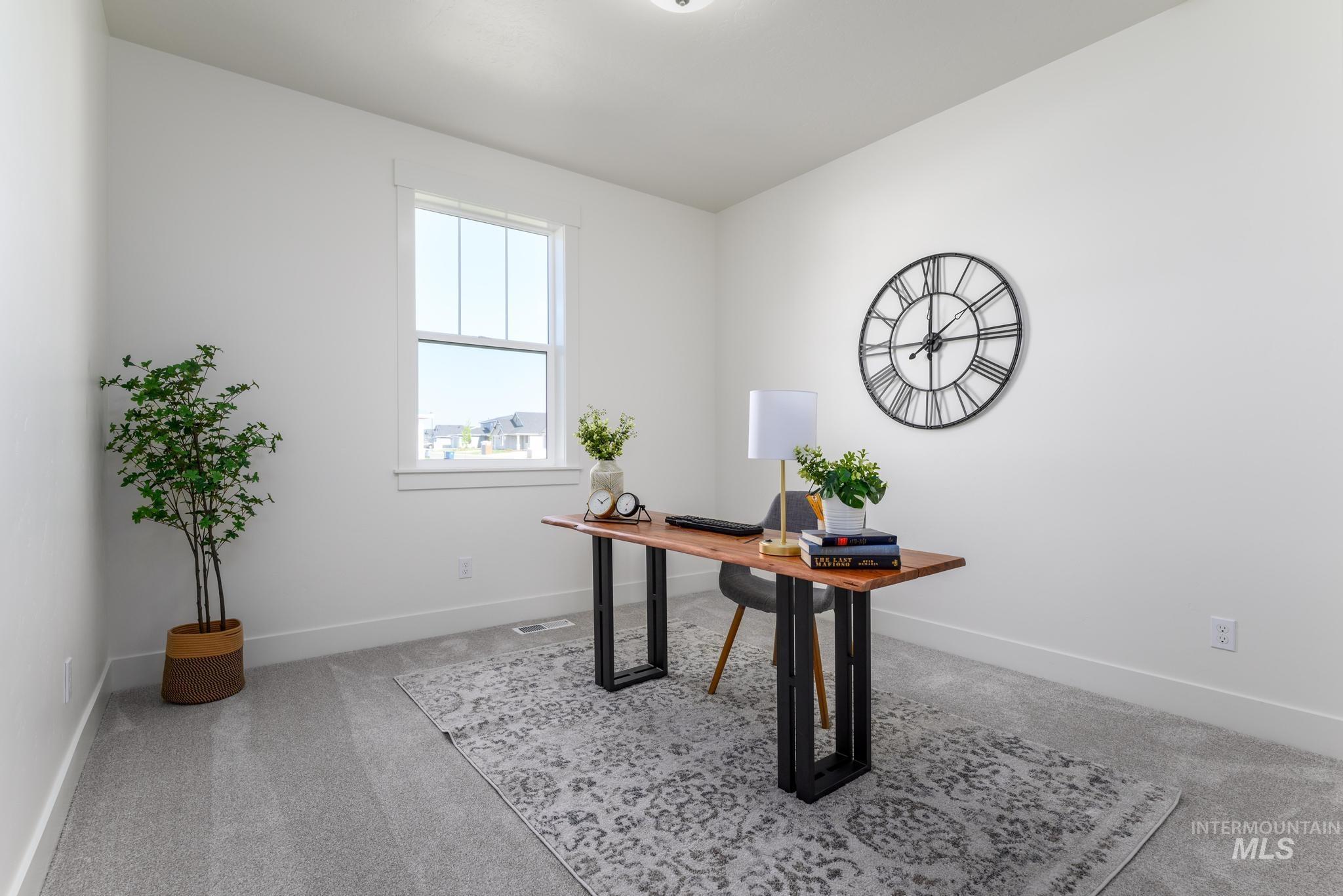Office featuring light carpet and baseboards