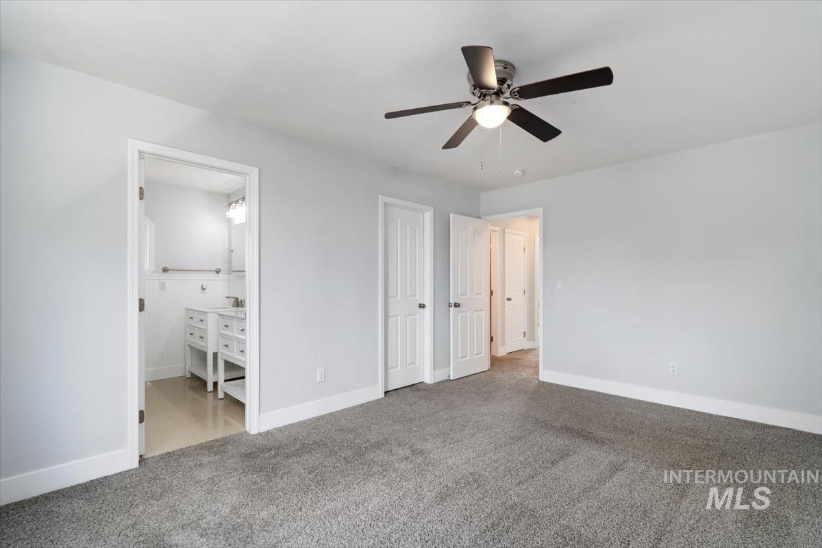 Spacious interior featuring neutral gray wall paint and plush gray carpeting