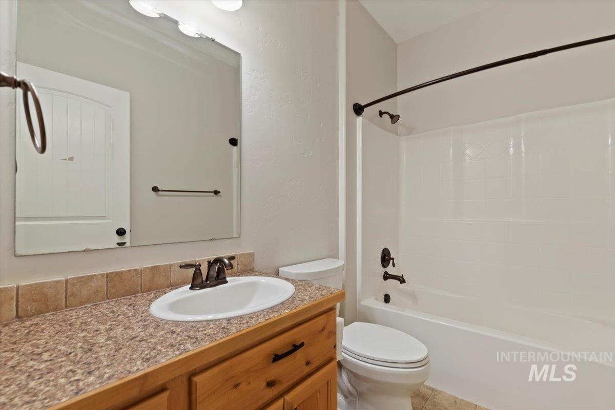 Full bath featuring vanity and bathtub / shower combination