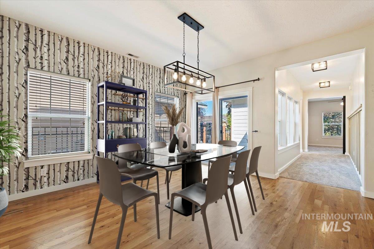 Dining room featuring light wood-style flooring and wallpapered walls