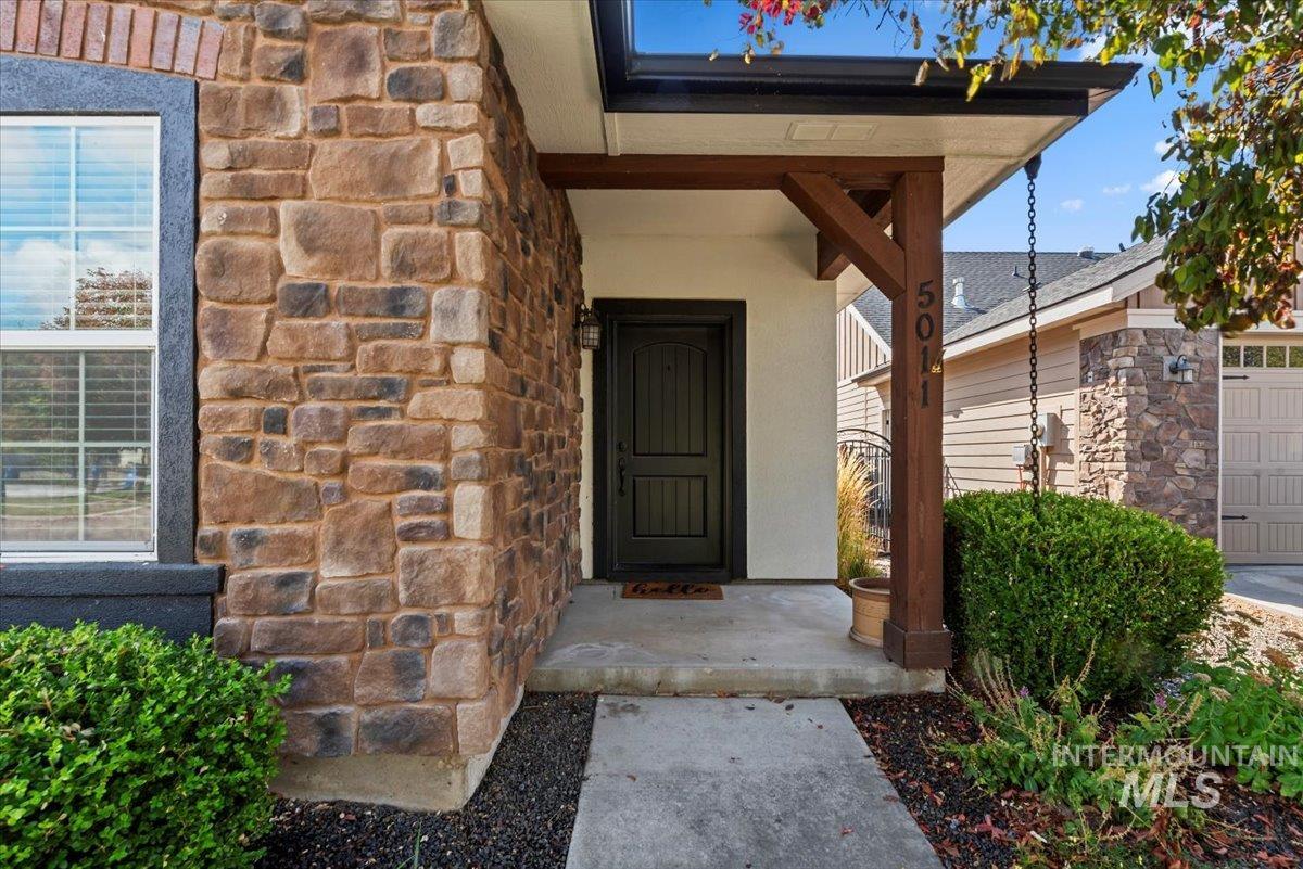 Property entrance featuring stone siding
