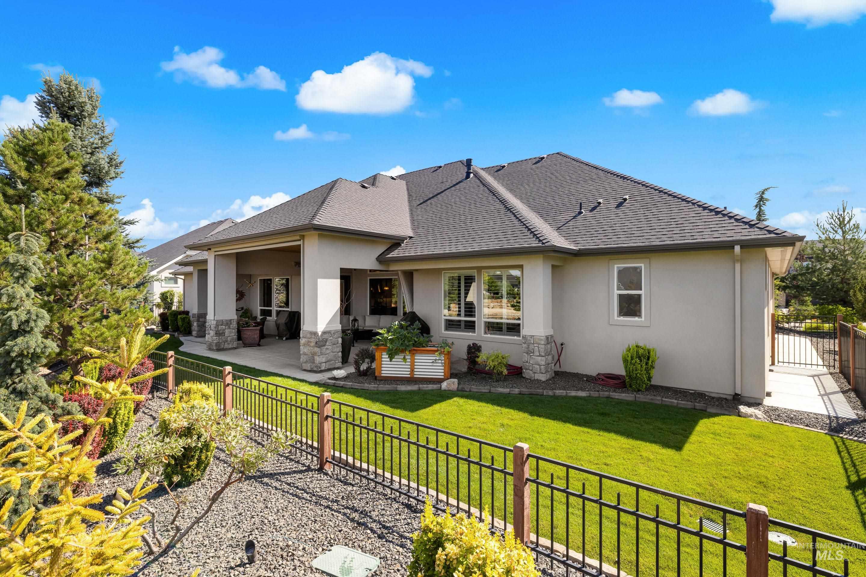 Rear view of property featuring a fenced backyard, a patio, stucco siding, and a shingled roof