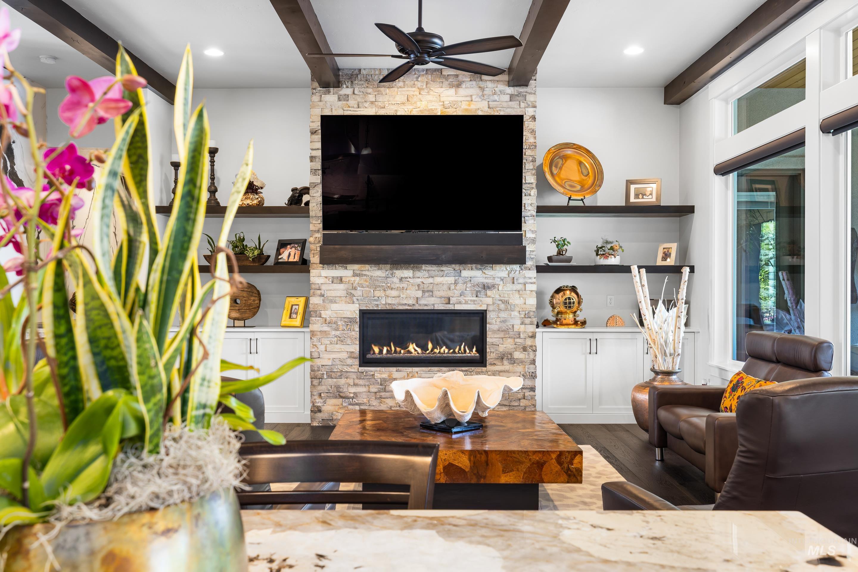 Living area featuring beam ceiling, dark wood finished floors, a fireplace, ceiling fan, and recessed lighting