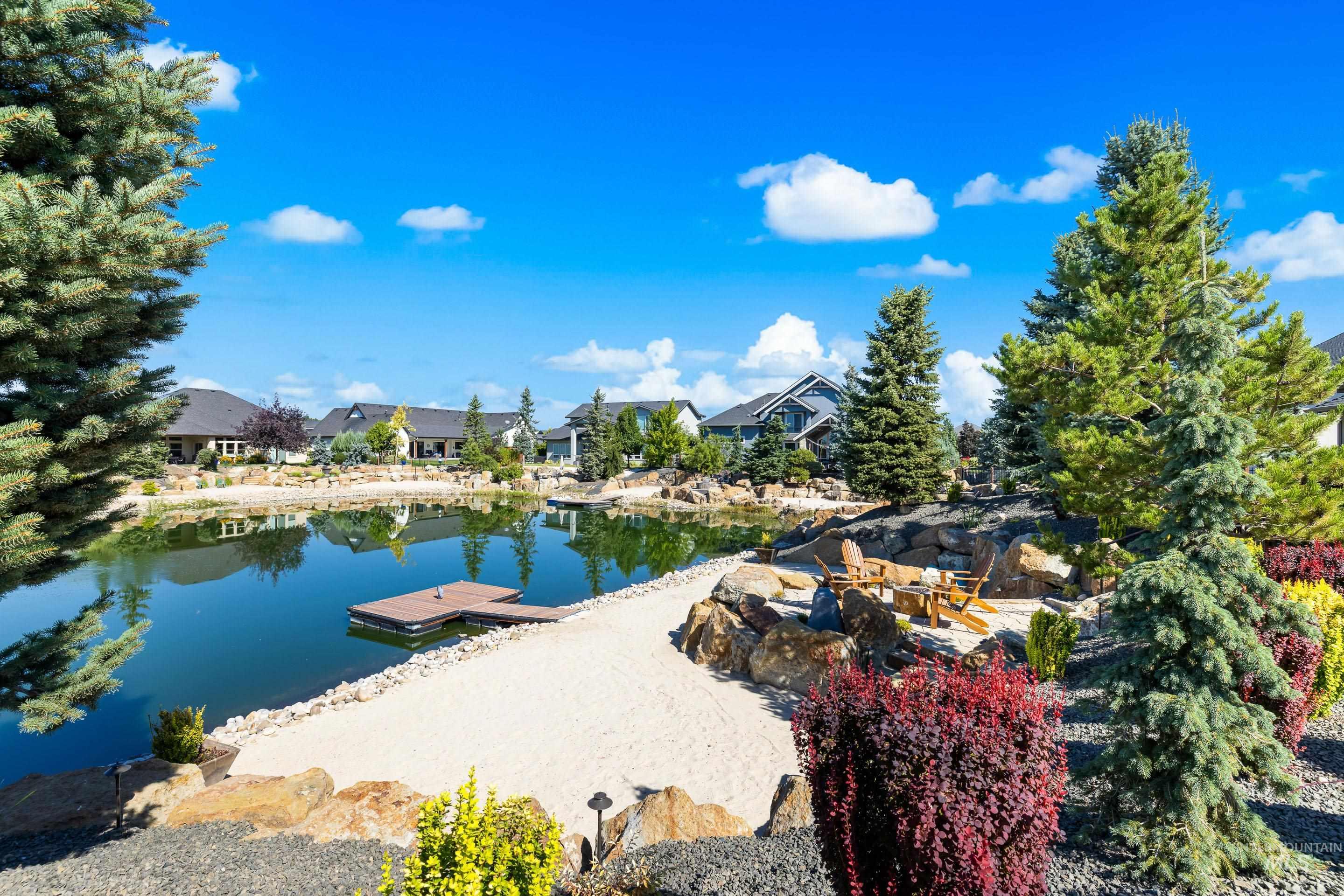 Water view featuring a floating dock and nearby suburban area