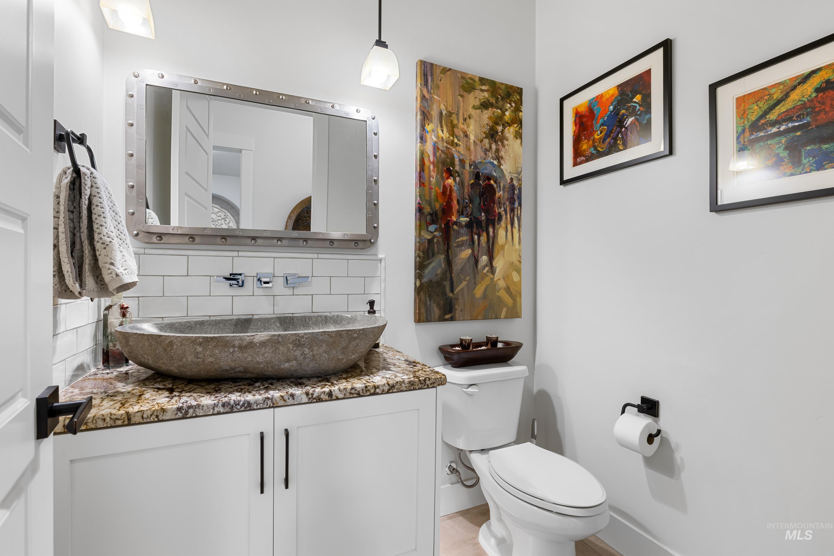Bathroom featuring backsplash and vanity