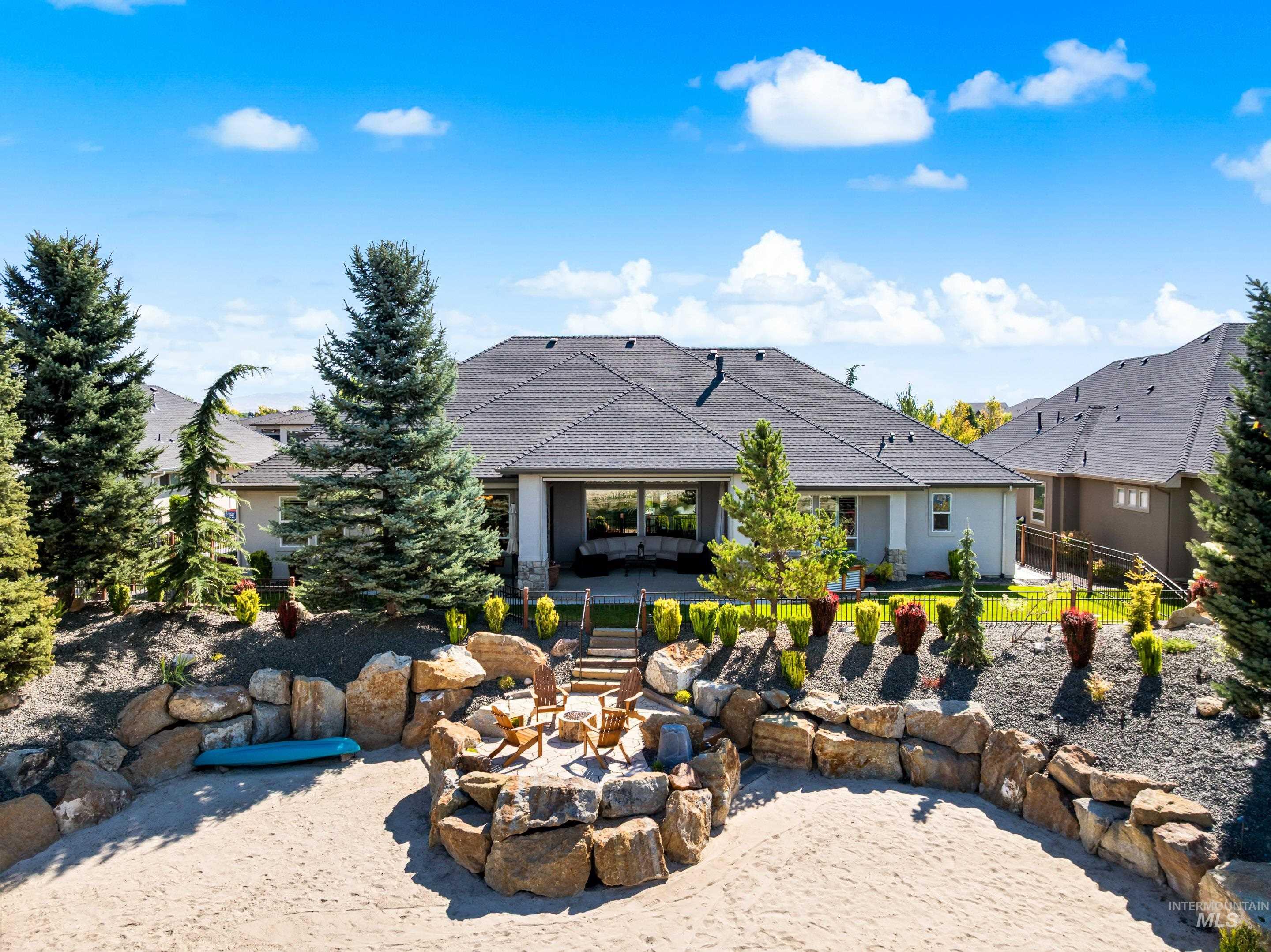 View of back of house with a patio area and an outdoor fire pit