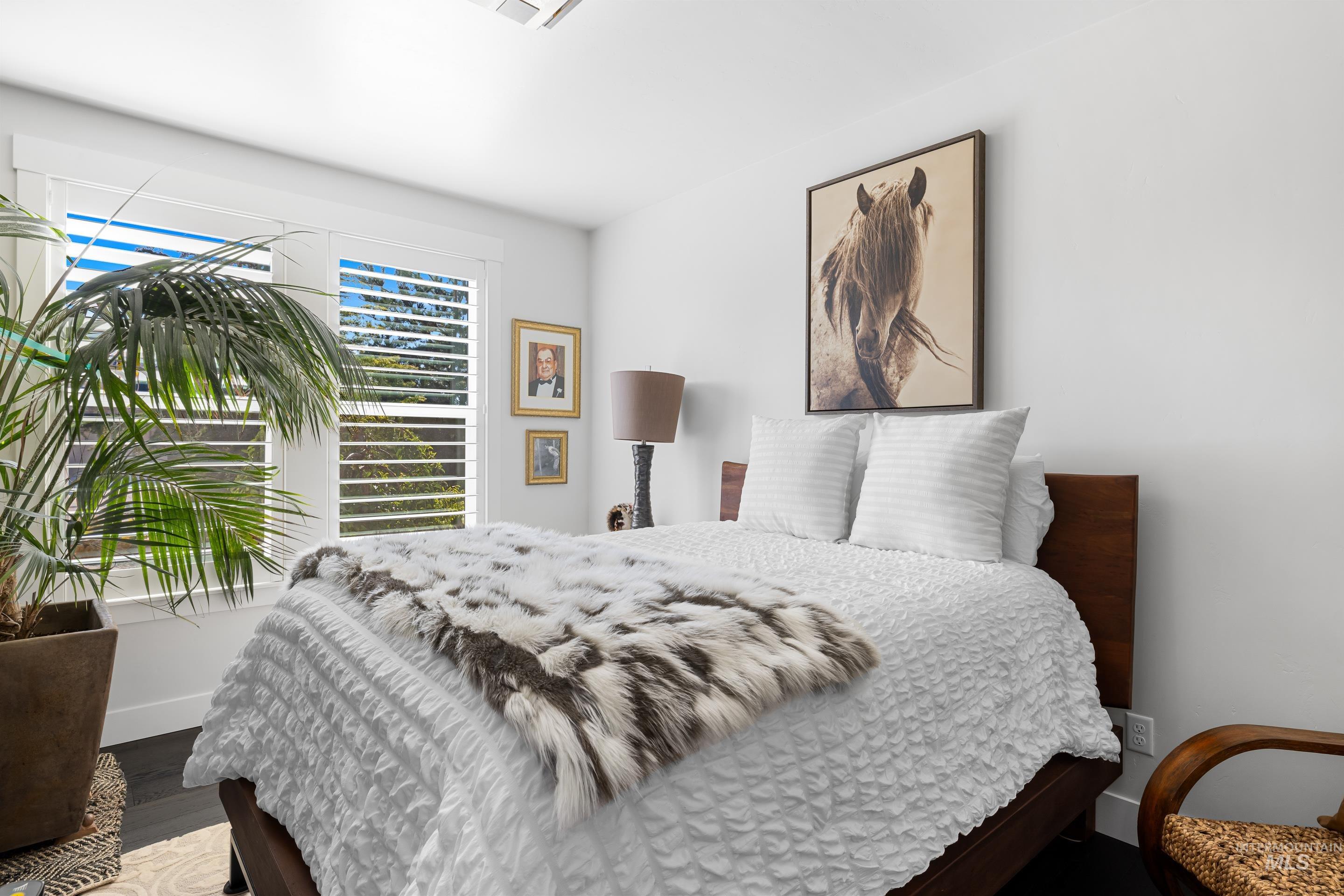 Bedroom with baseboards and wood finished floors