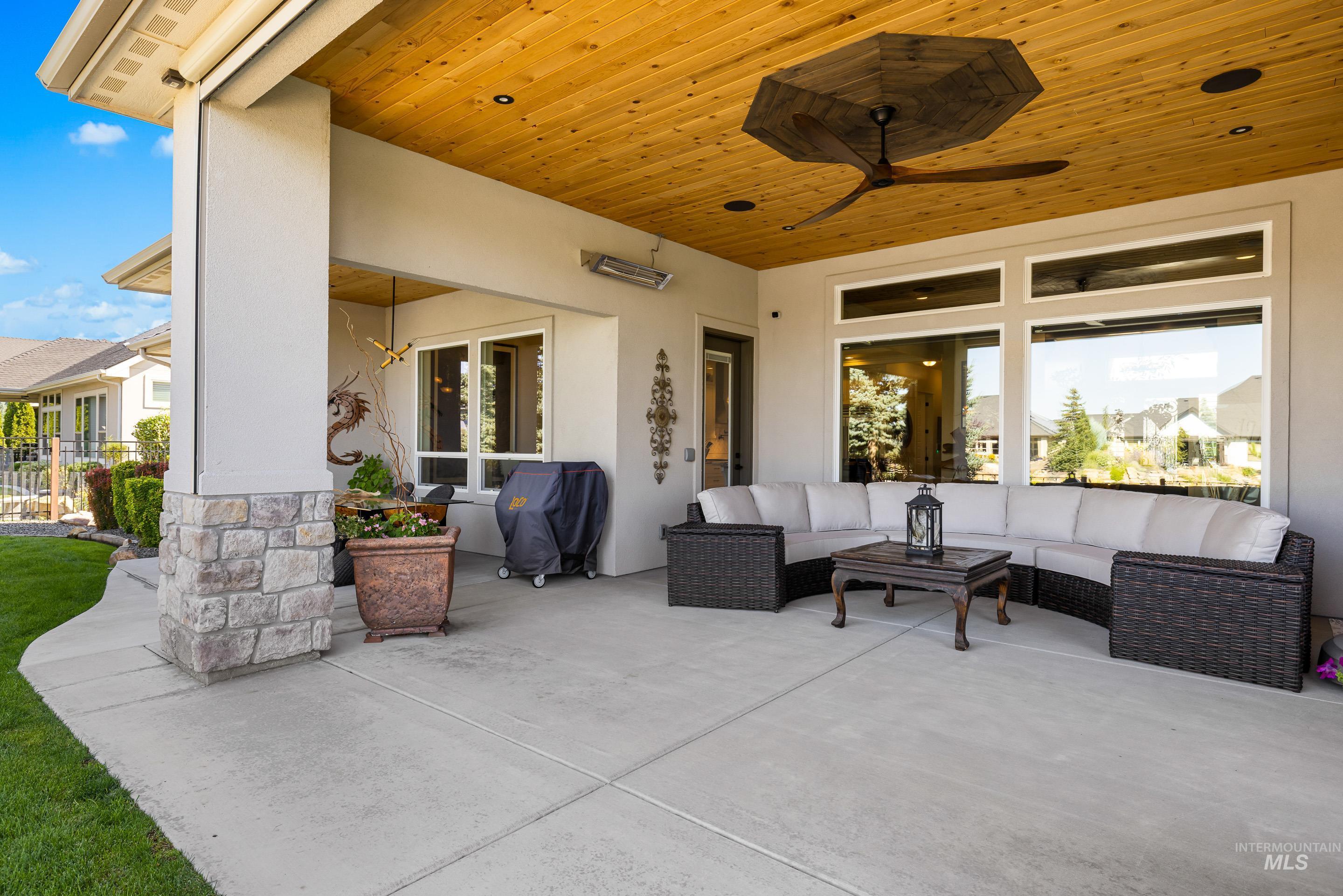 View of patio with grilling area and an outdoor hangout area
