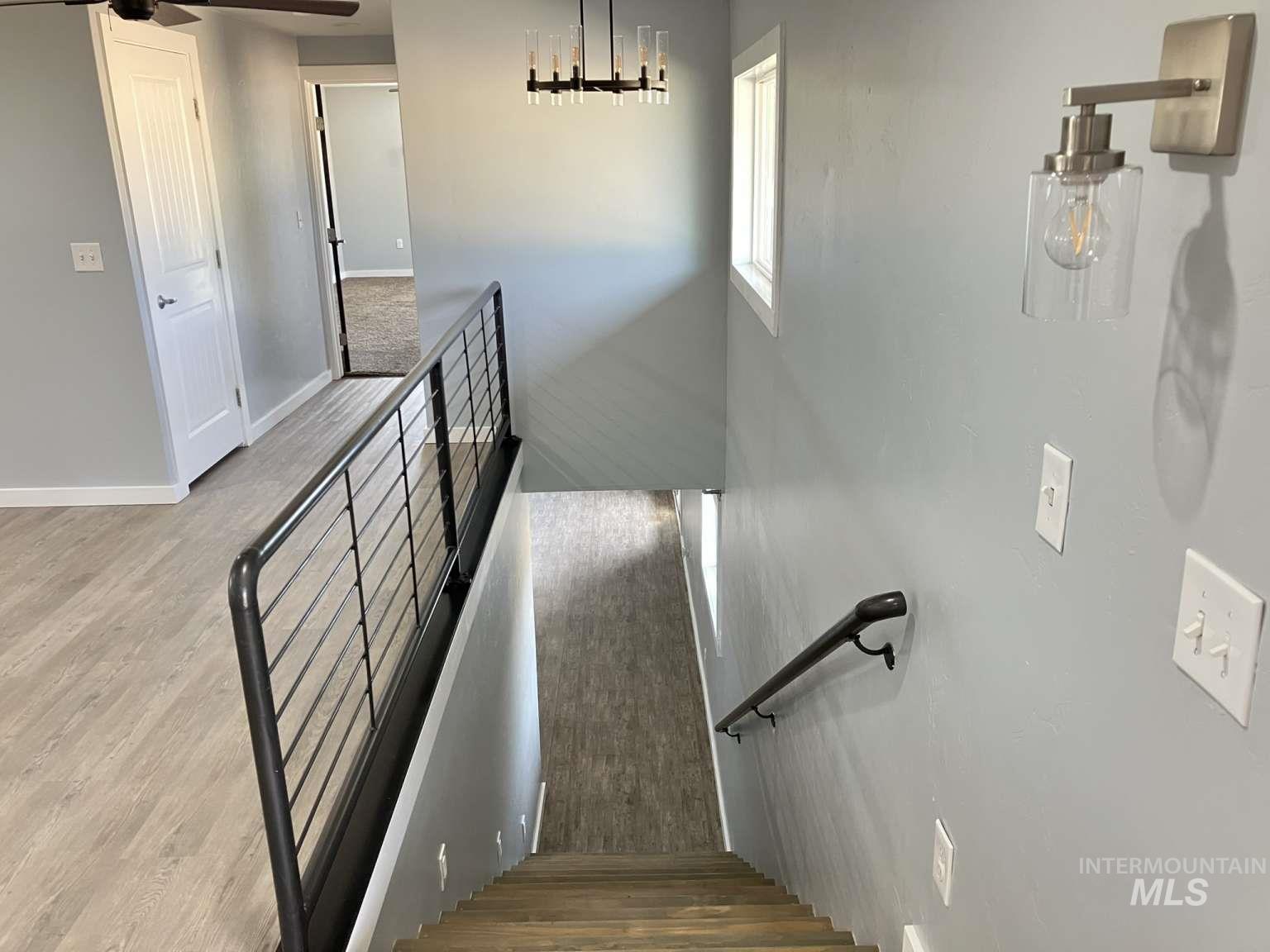 Stairway featuring baseboards and wood finished floors