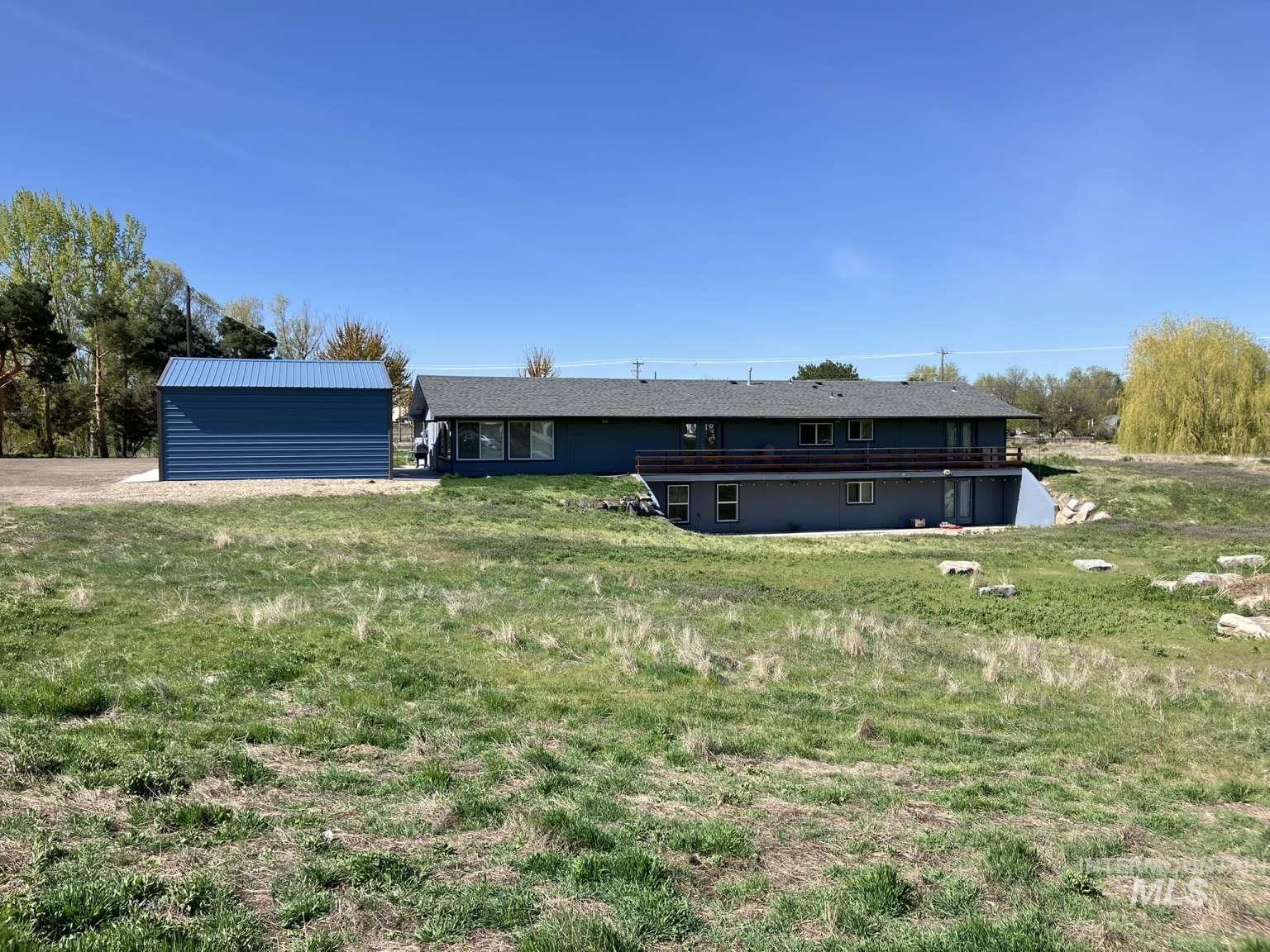 Back of house with a lawn