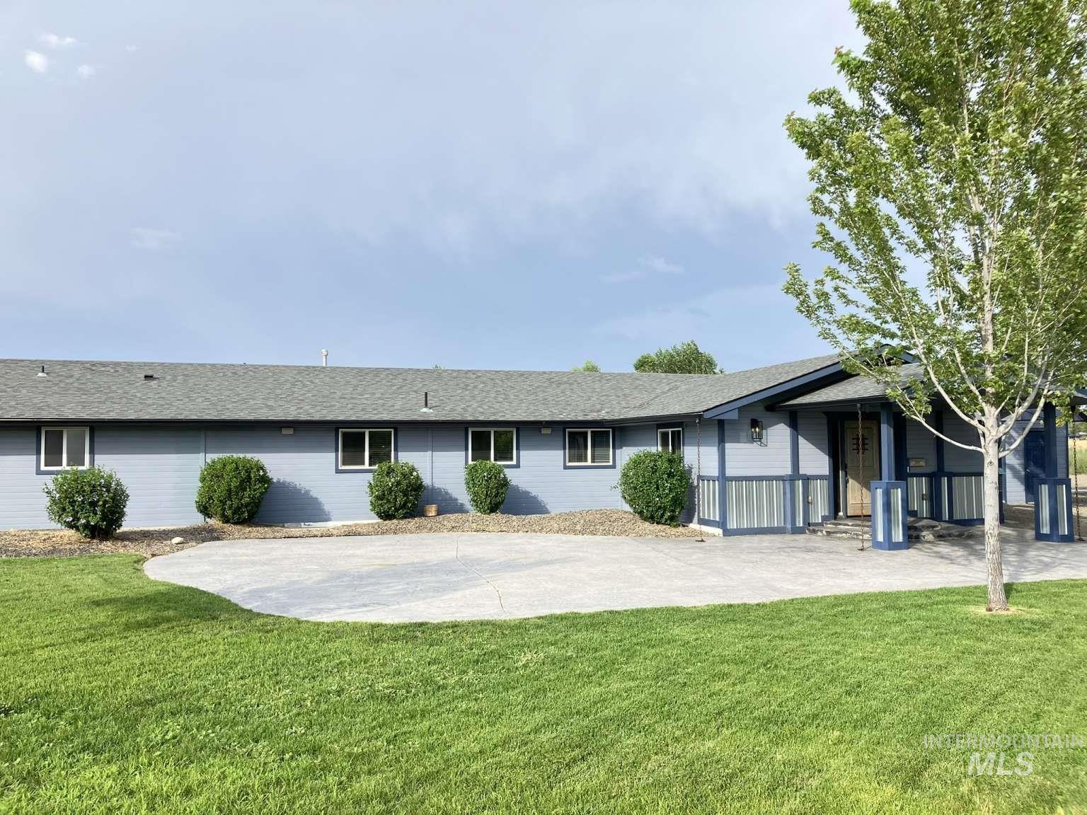 Back of house with a yard and roof with shingles