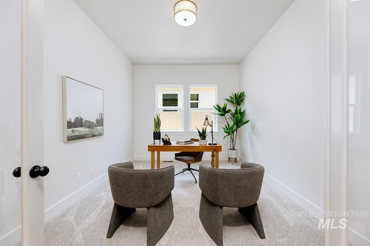 Office space featuring light carpet and baseboards