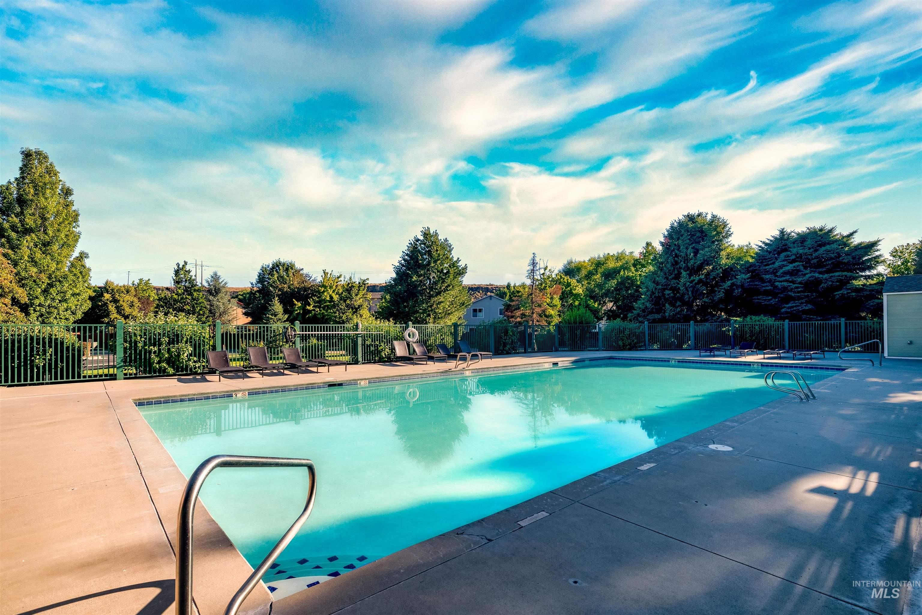 Community pool with a patio
