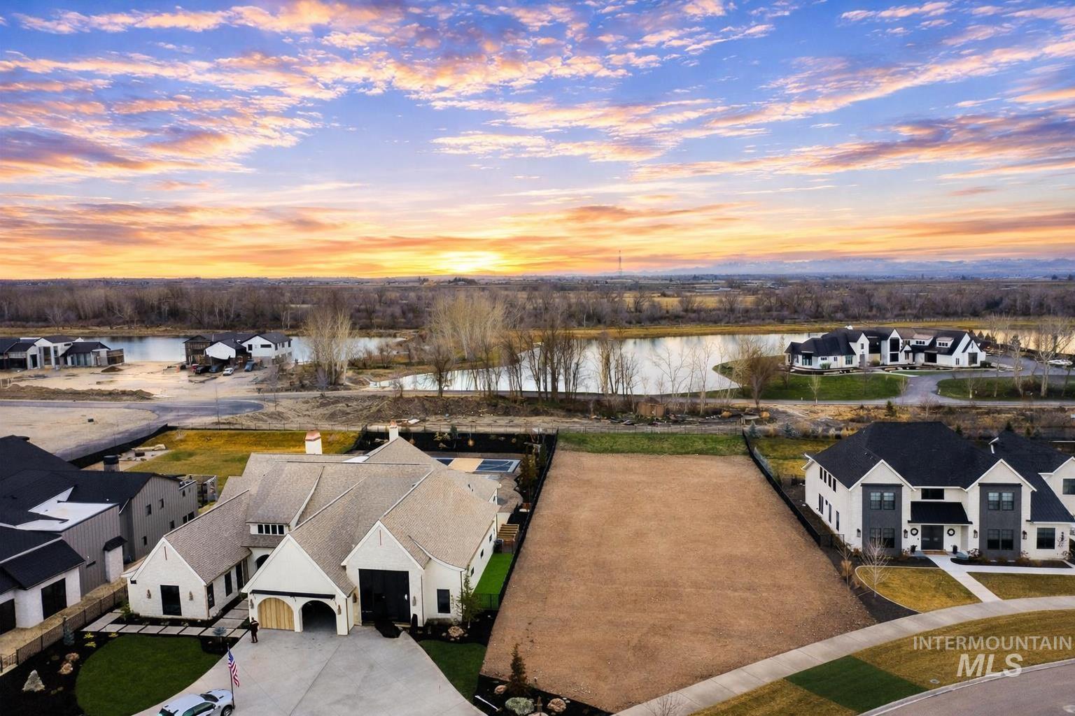 Aerial view at dusk of a water view and a residential view