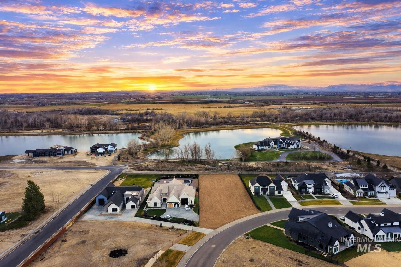 Aerial view at dusk of a water view and a residential view
