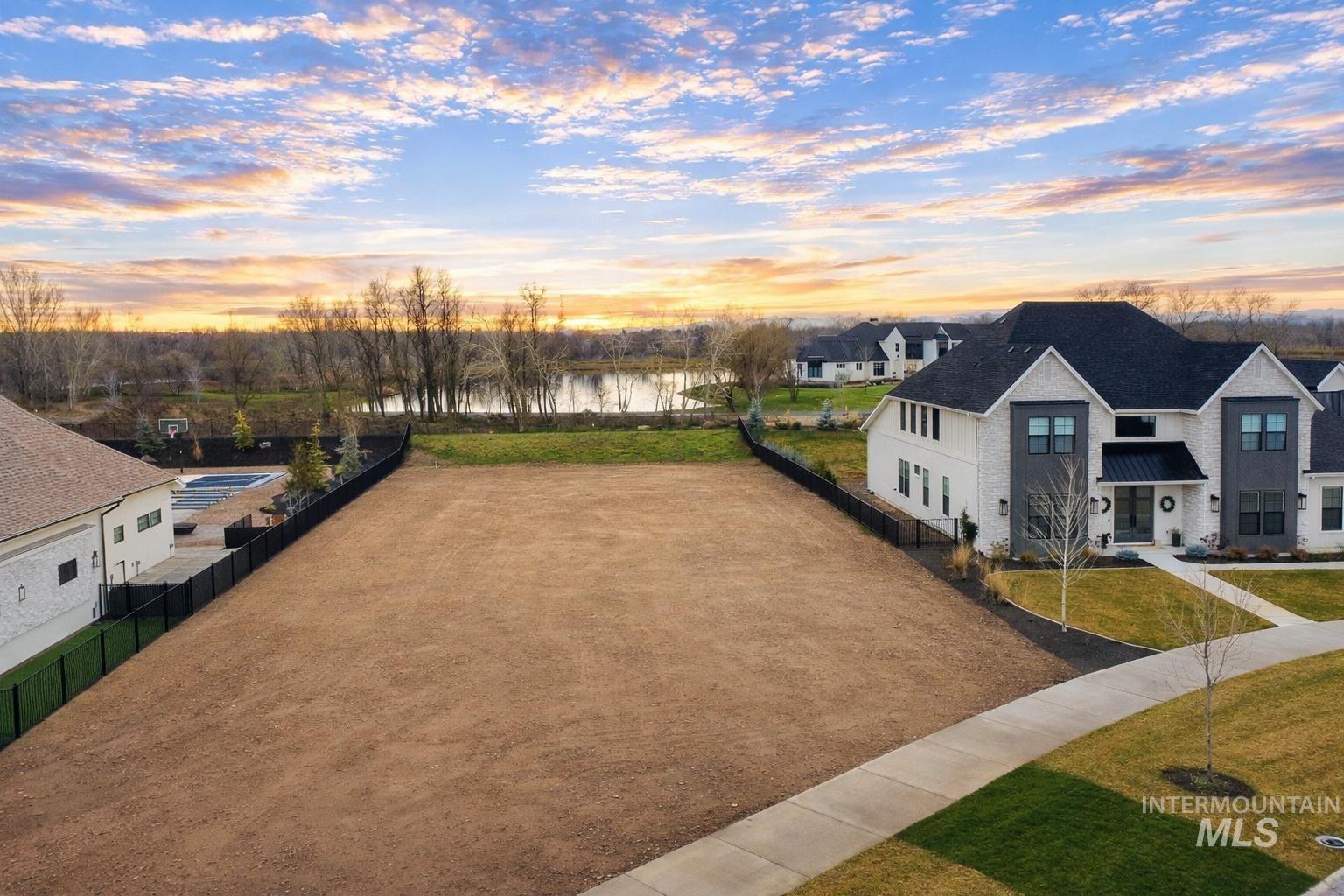 Yard at dusk featuring a water view