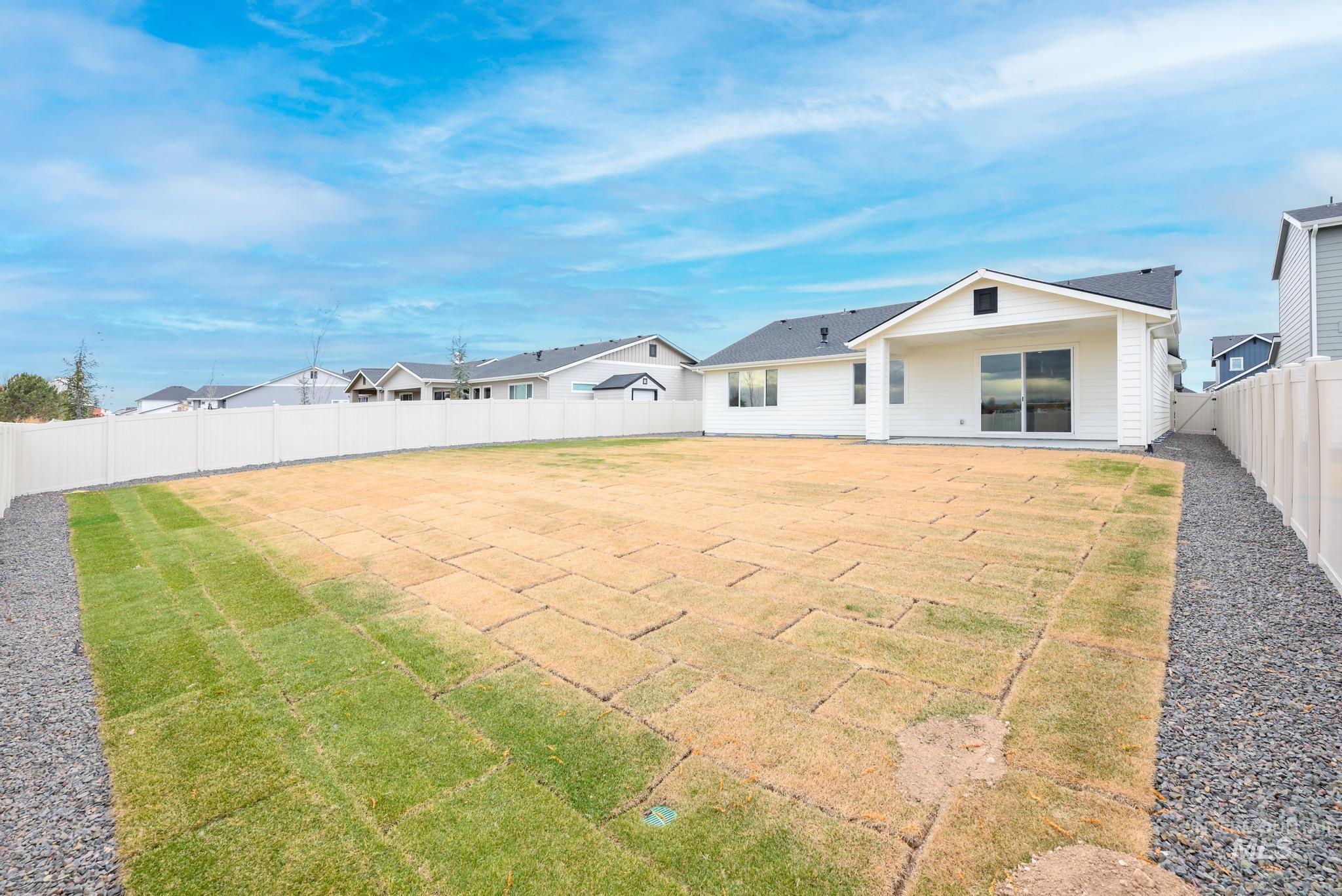 Rear view of house featuring a fenced backyard and a residential view