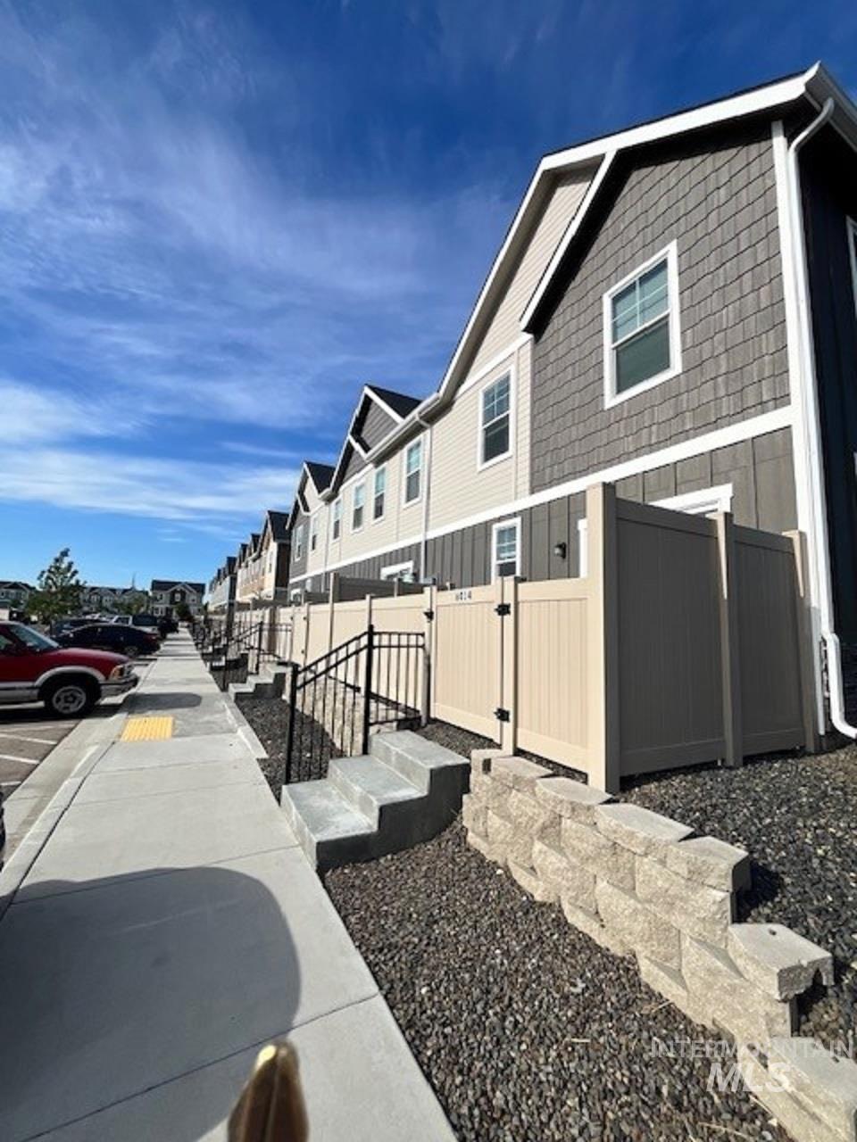 View of home's exterior featuring a residential view and a gate