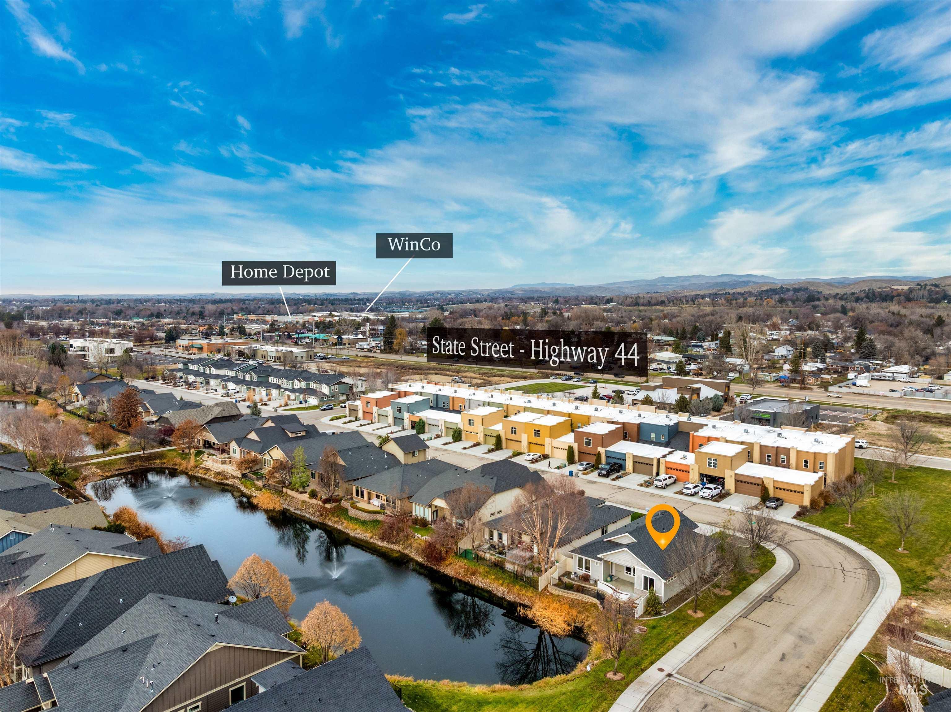 Aerial perspective of suburban area with a nearby body of water